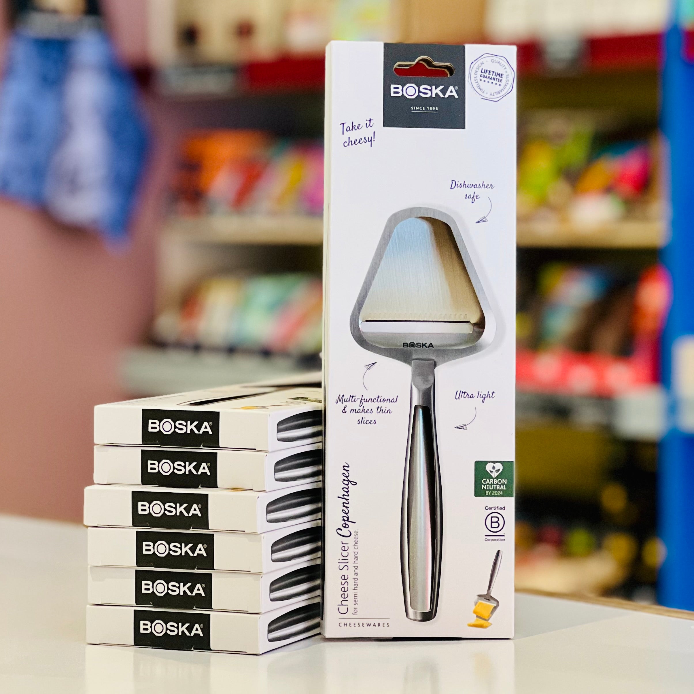 Boska cheese knife packaging with product on a blurred store shelf background
