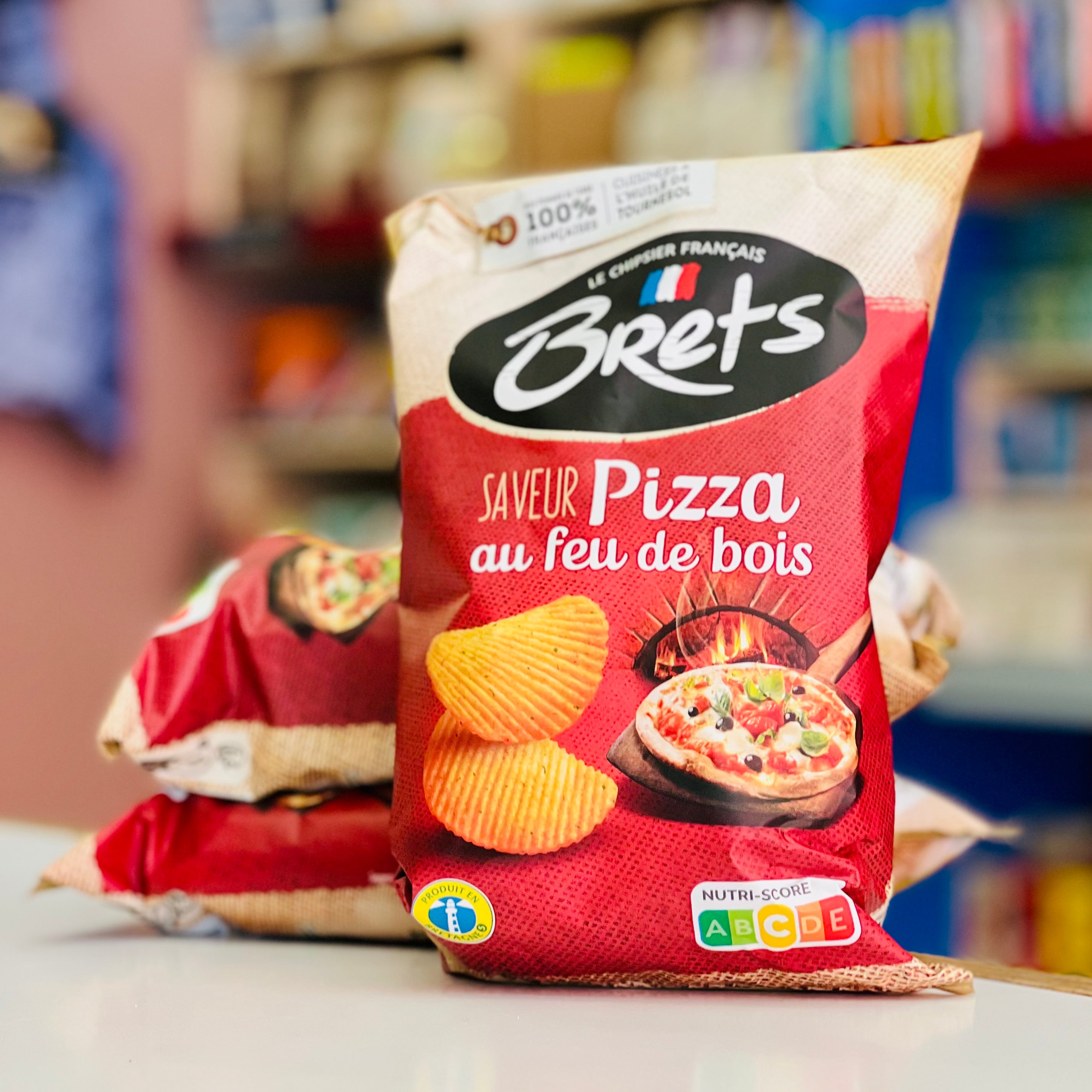 Packaged chips with pizza flavor branding in a store setting