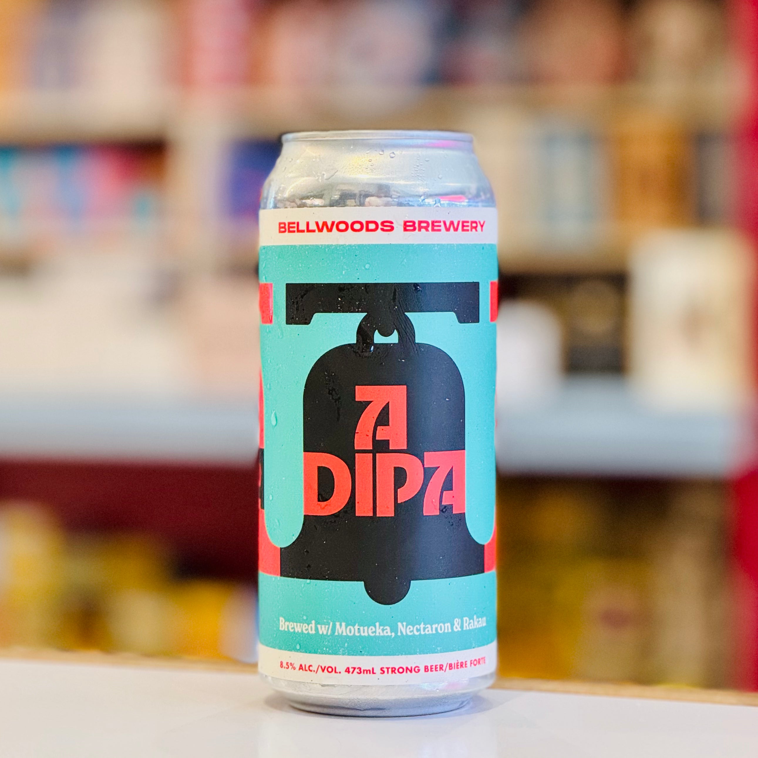 Beer can with 'ADIPA' branding on a blurred background