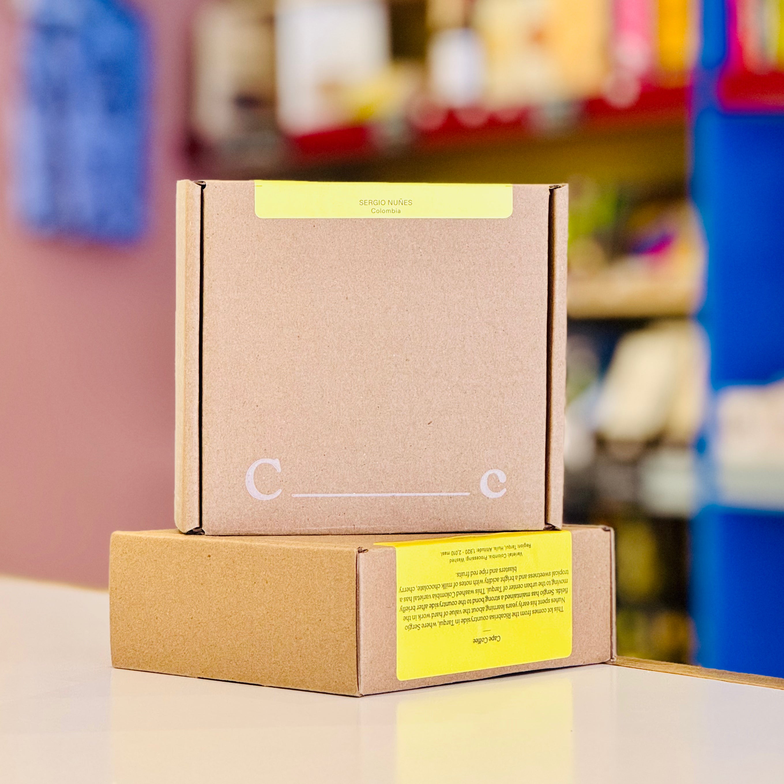 Brown cardboard box with yellow labels on a blurred background