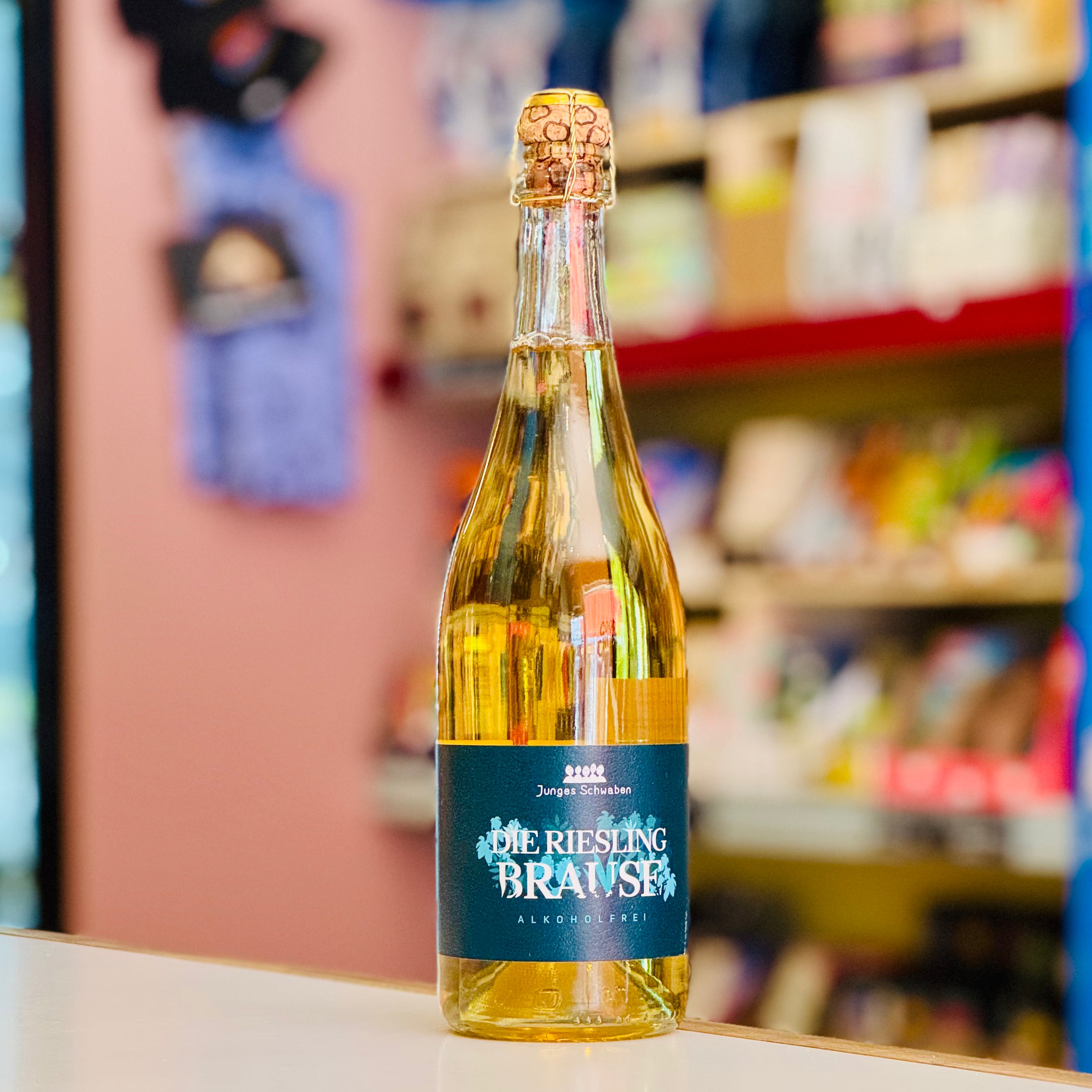 Bottle of 'Die Riesling Brause' on a shelf with blurred store background