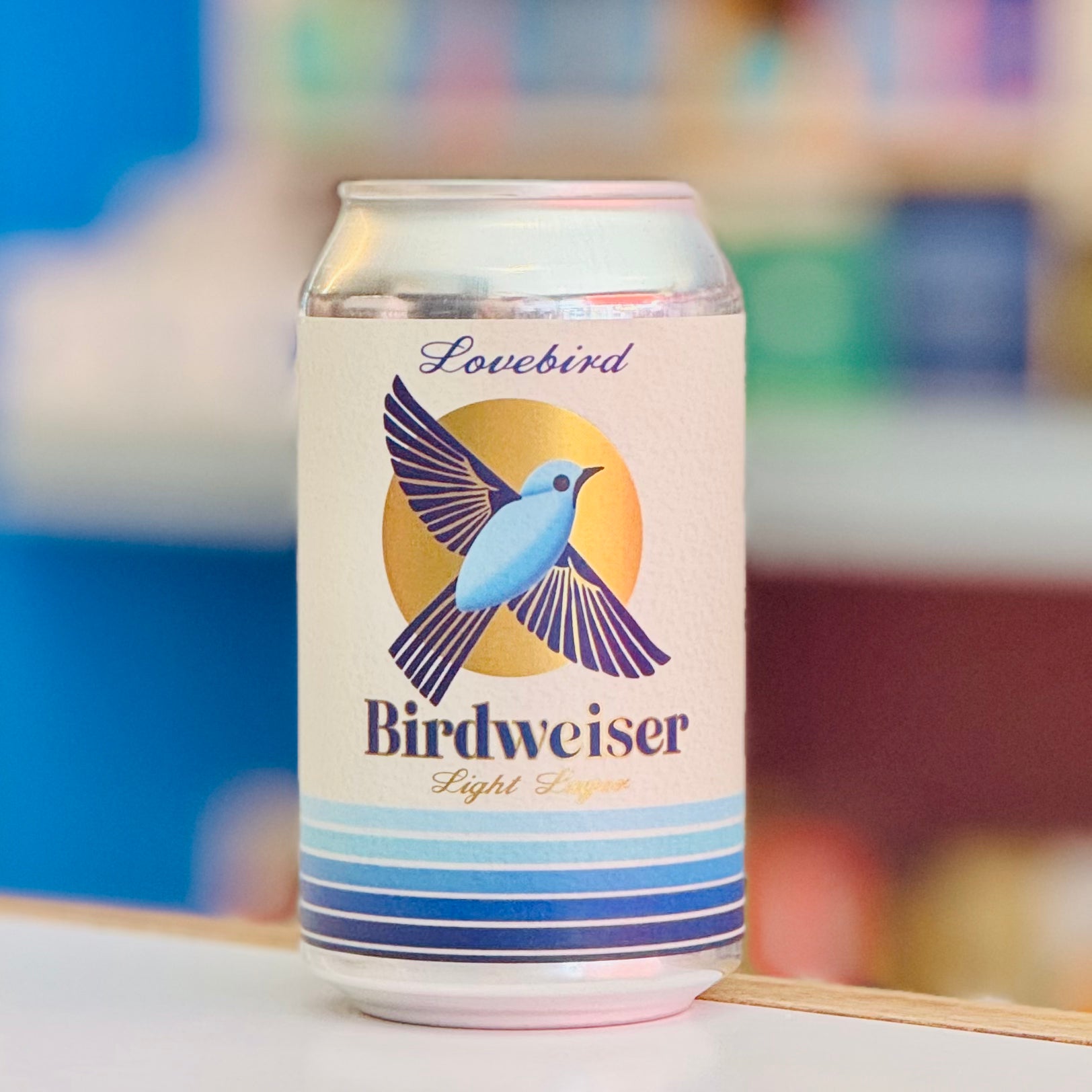 Can of Birdweiser Light Lager with a bird graphic on a blurred background