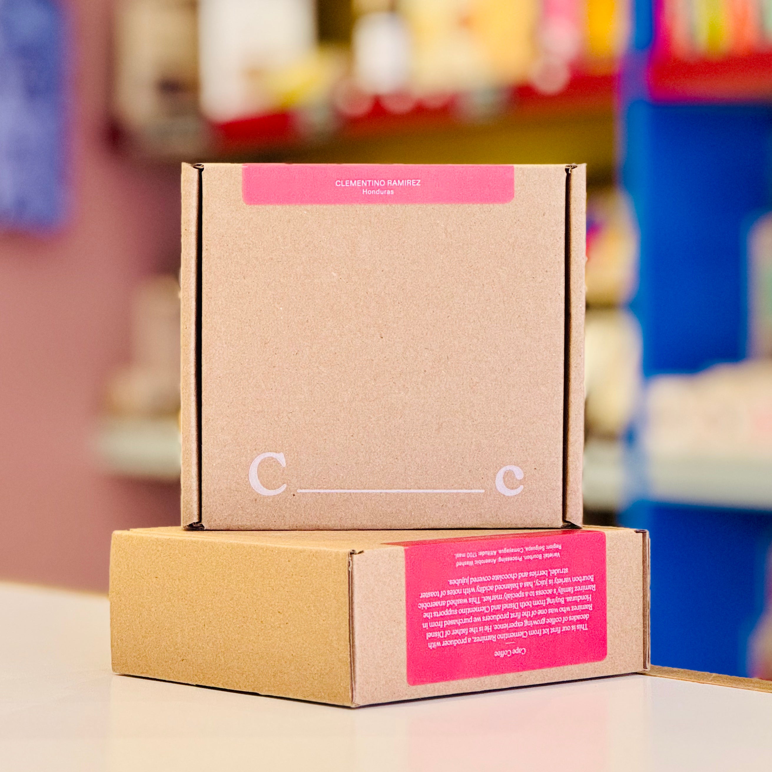 Cardboard box with pink labels on a blurred background