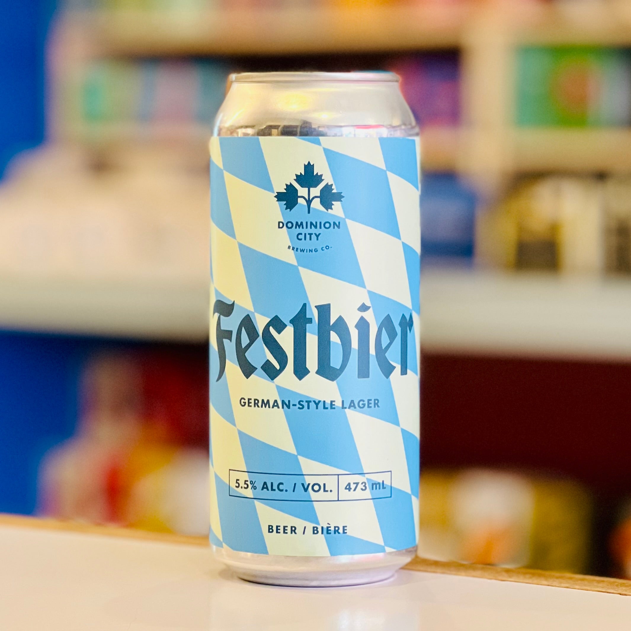 Festbier can with blue and white checkered design on a blurred background