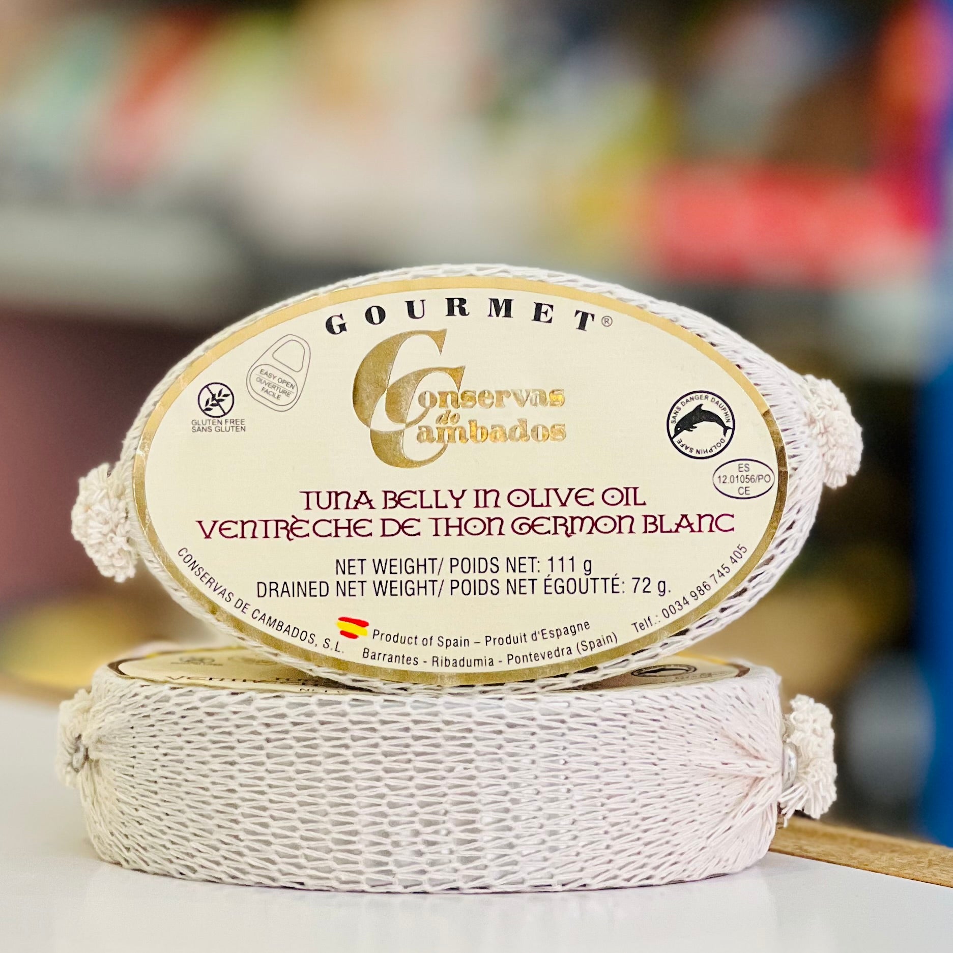 Gourmet tuna belly in olive oil packaging with brand name on a blurred background