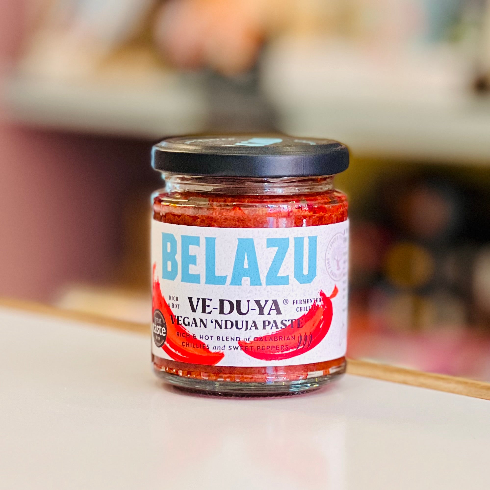 Jar of Belazu Vegan 'Nduja Paste on a blurred background