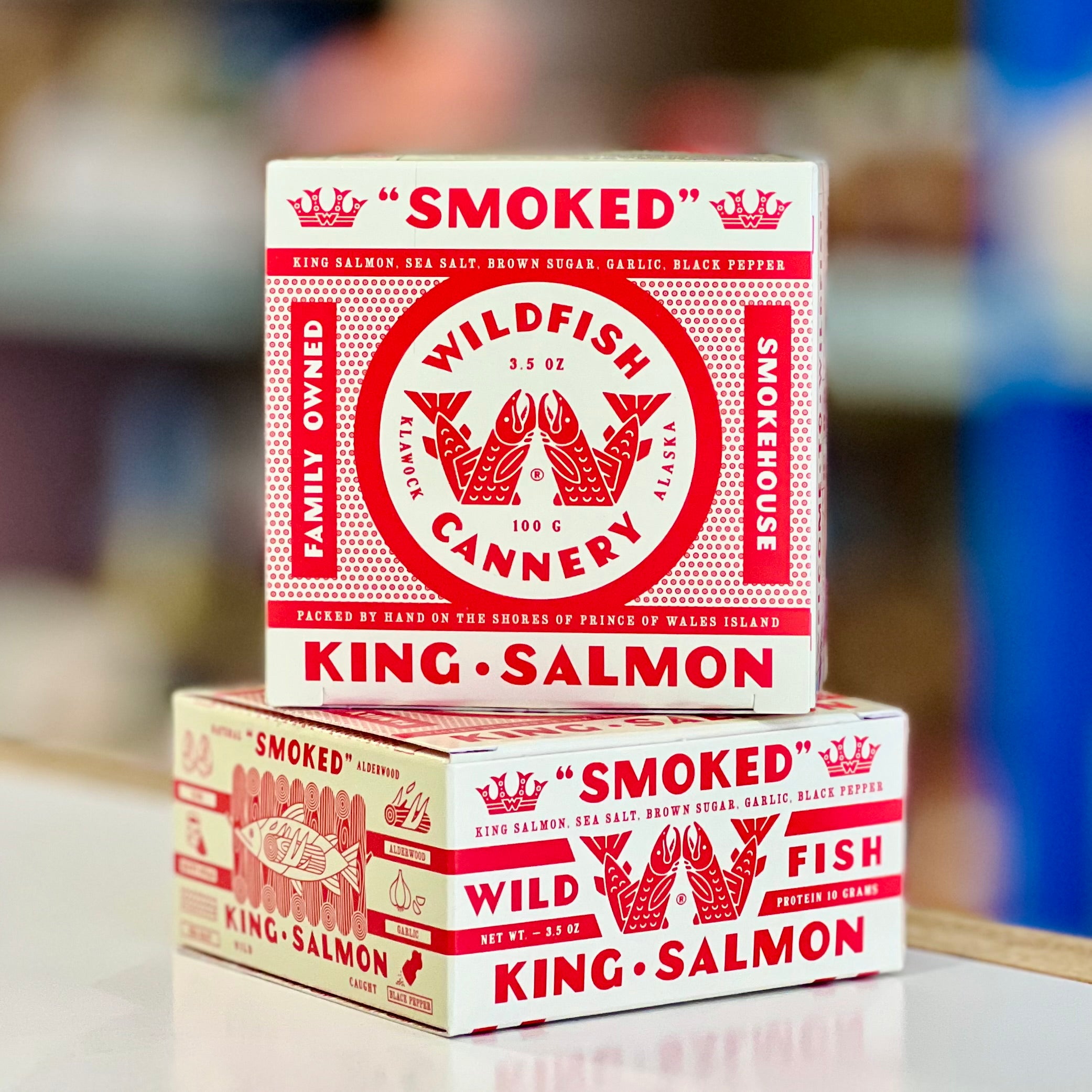 Two boxes of 'Smoked Wild Fish Cannery King Salmon' on a blurred background