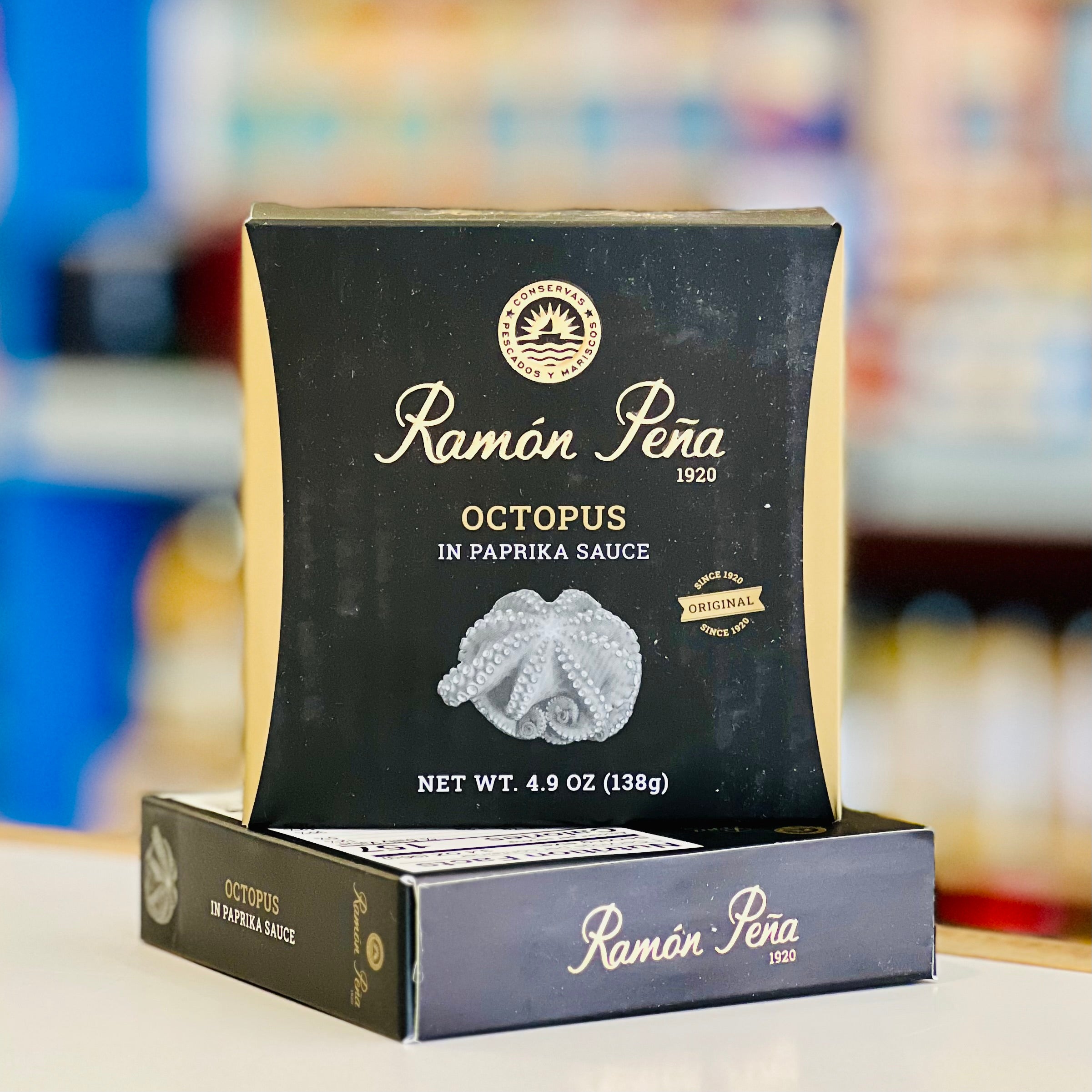 Ramon Pena octopus in paprika sauce packaging on a table with a blurred background