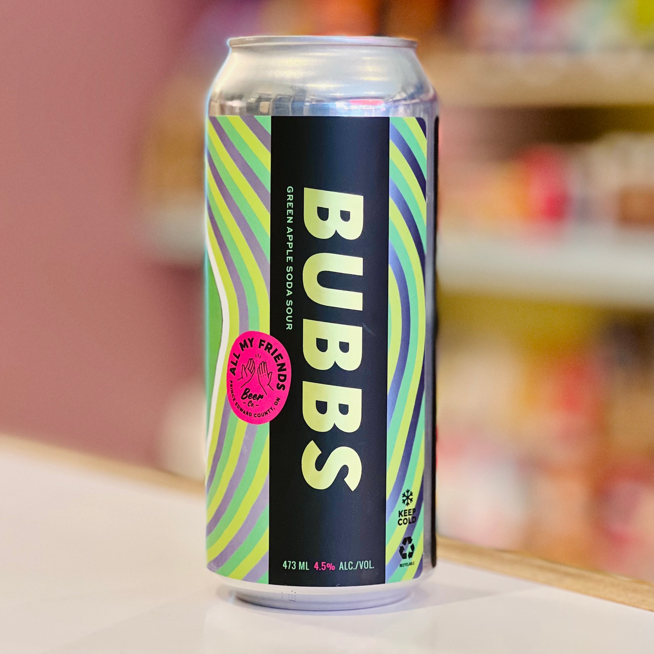 Can of BUBBS soft drink with colorful label on a blurred background