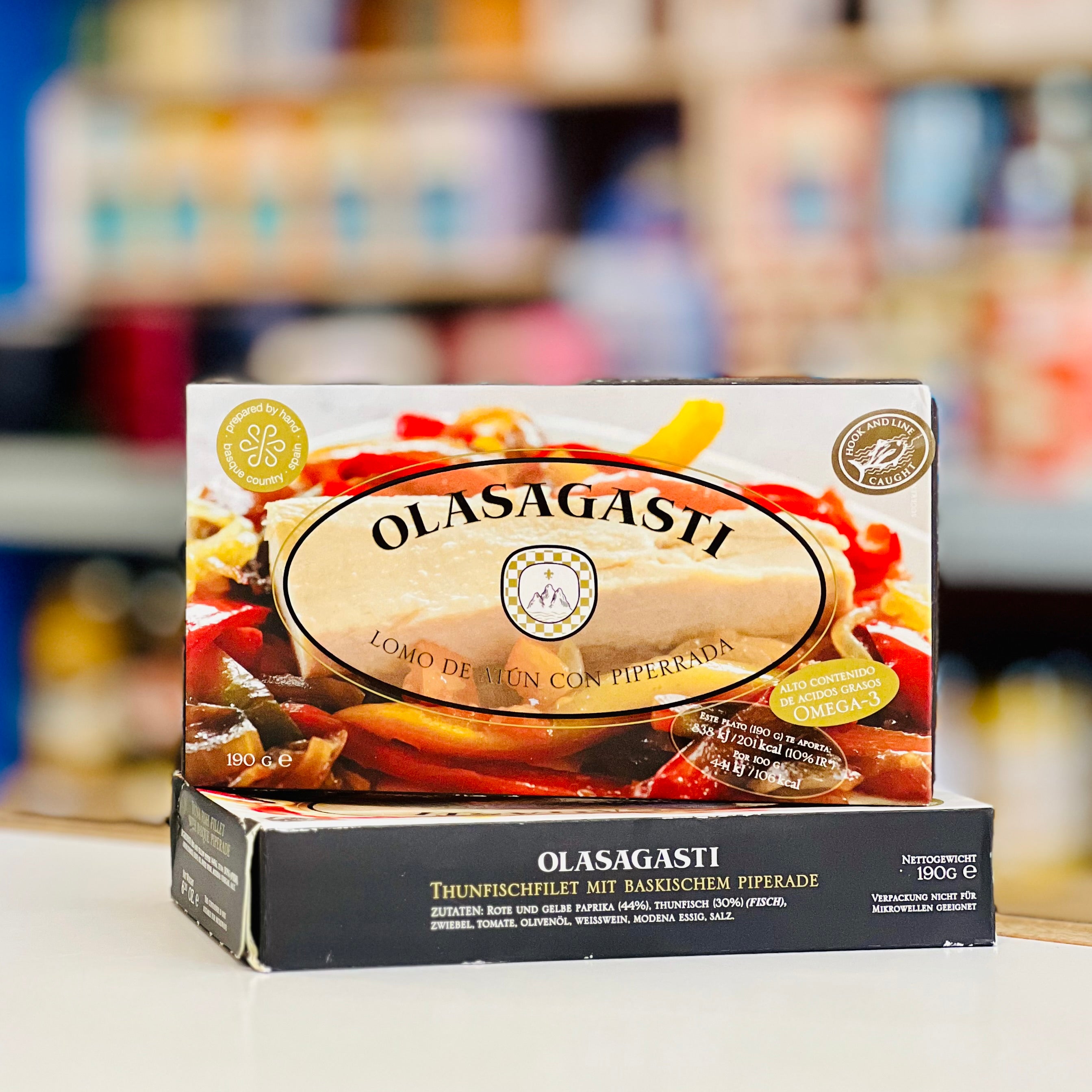 Olasagasti food product packaging with blurred store shelves in the background