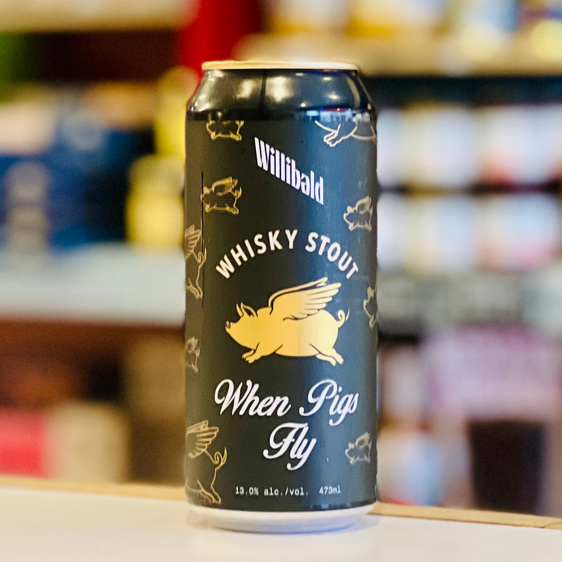 Can of Willibald Whisky Stout with a pig illustration on a blurred background