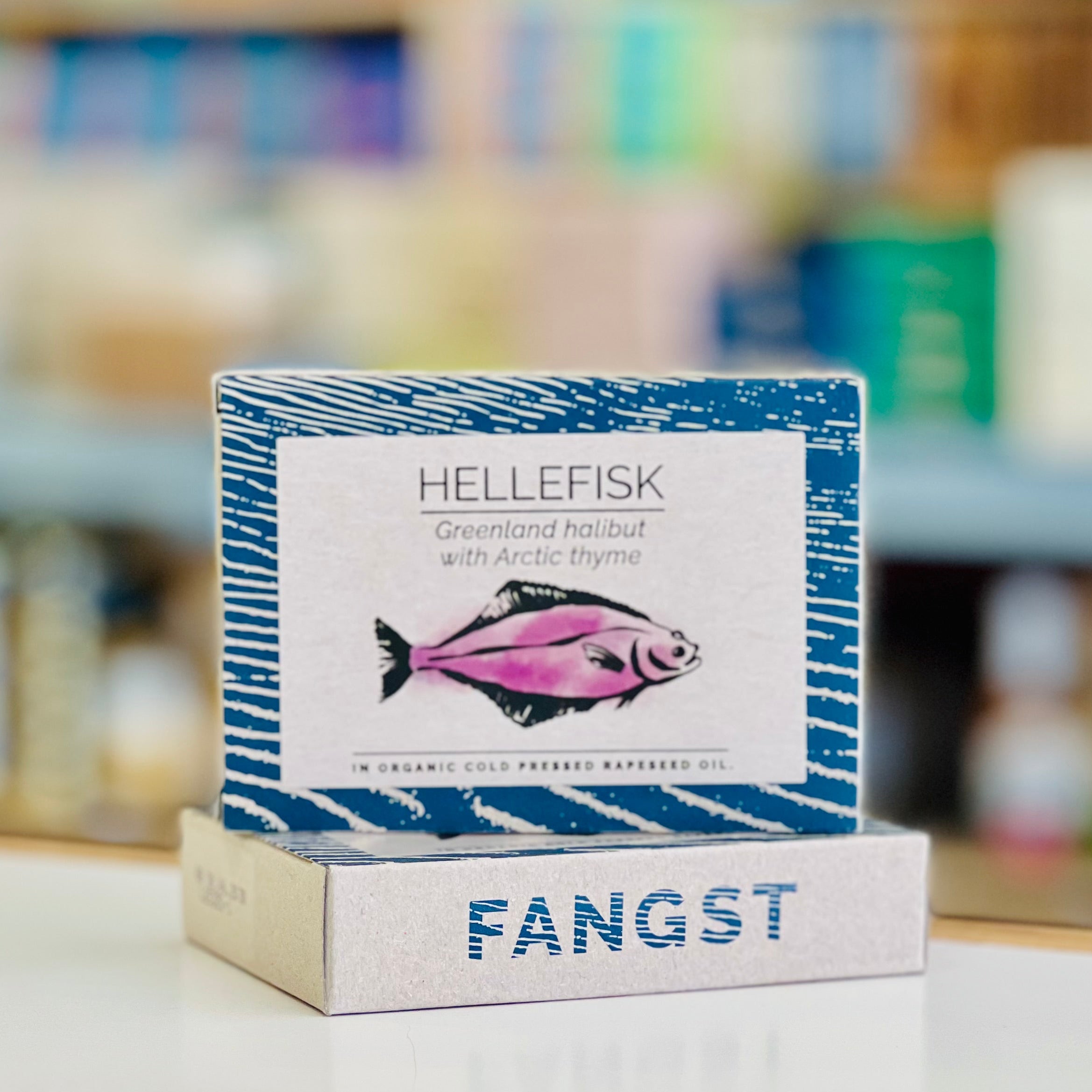 Hellefisk Fangst product packaging with a fish illustration on a blurred background