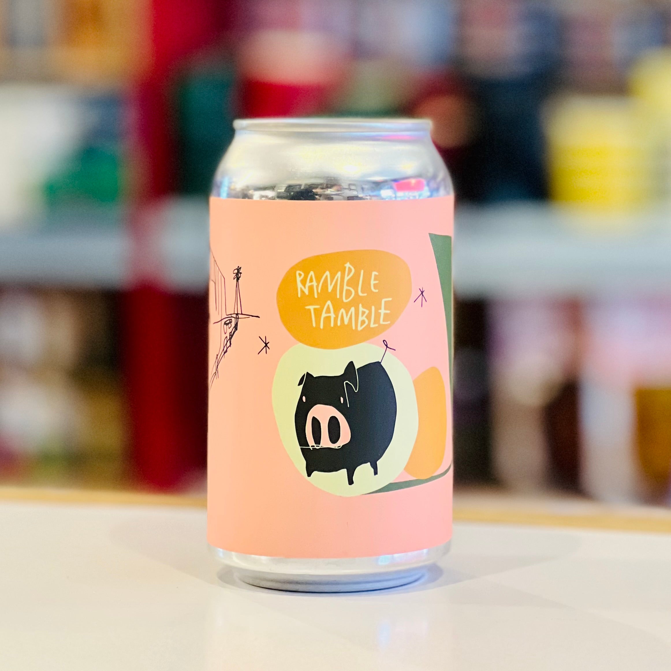 Can with a colorful label featuring a pig illustration and text on a blurred background