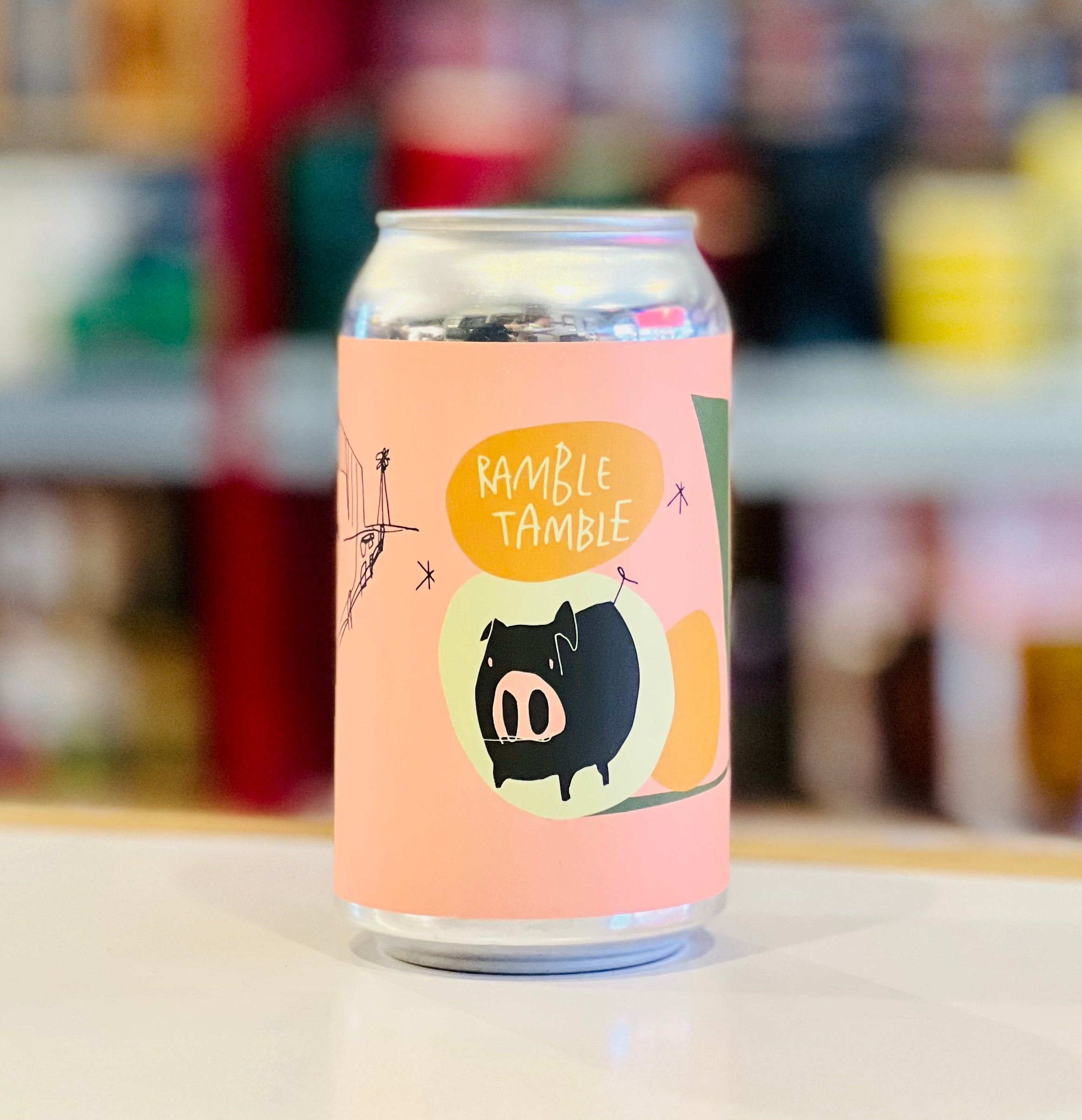 Can with a colorful label featuring a pig illustration and text on a blurred background