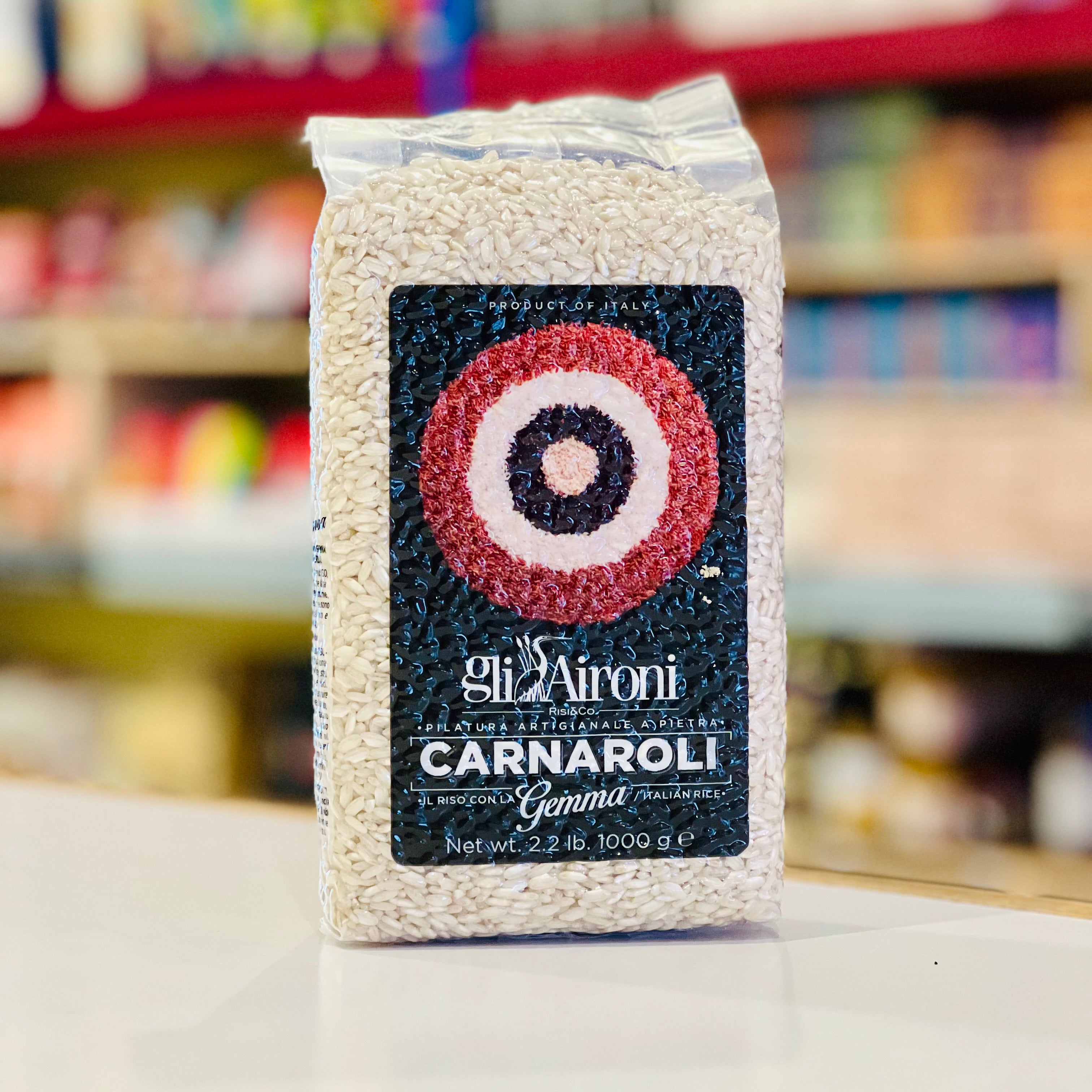 Bag of Gli Aironi Carnaroli rice with a blurred store shelf in the background