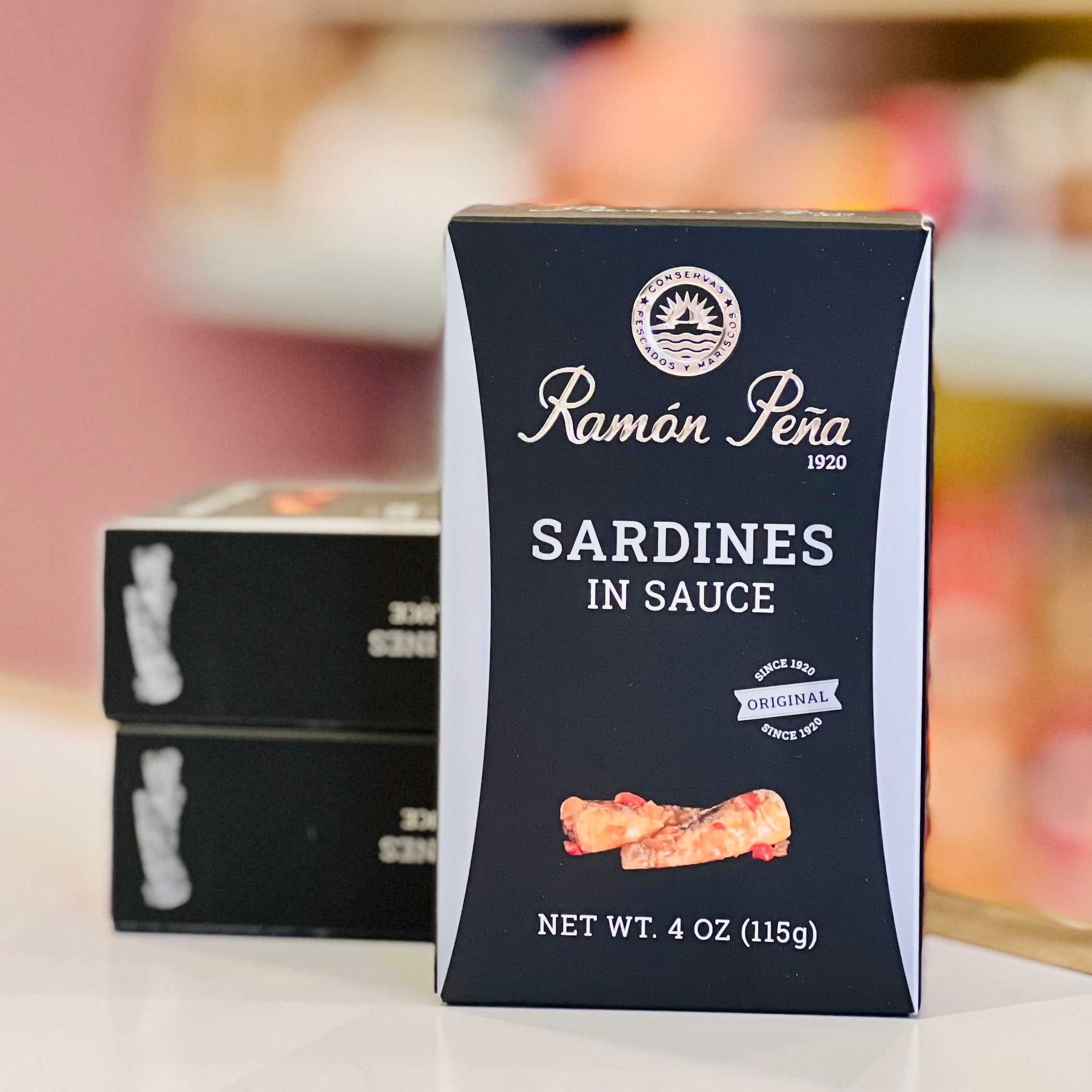 Box of Ramon Pena sardines in sauce on a blurred background