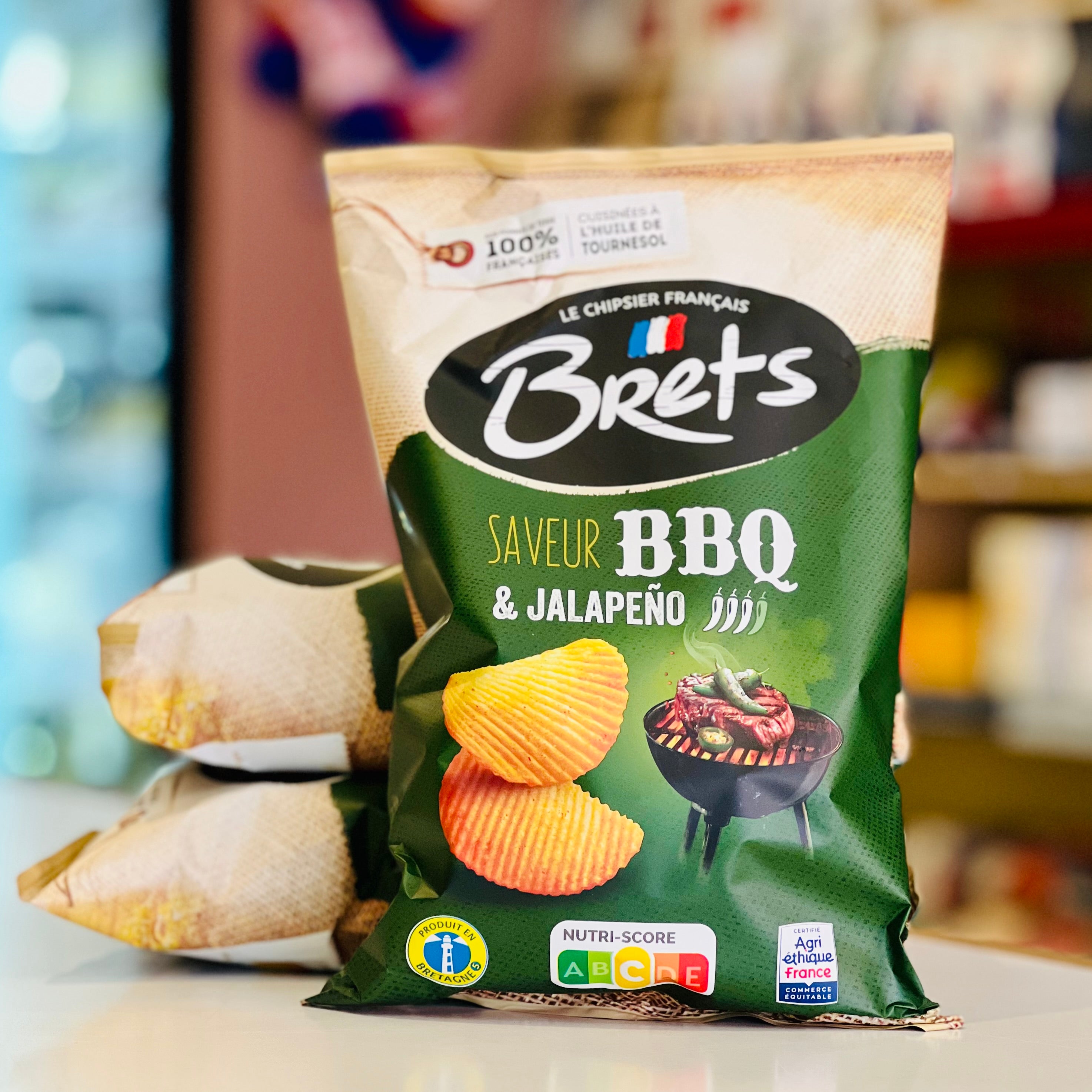 Green bag of Brets BBQ & Jalapeño flavored chips on a blurred background