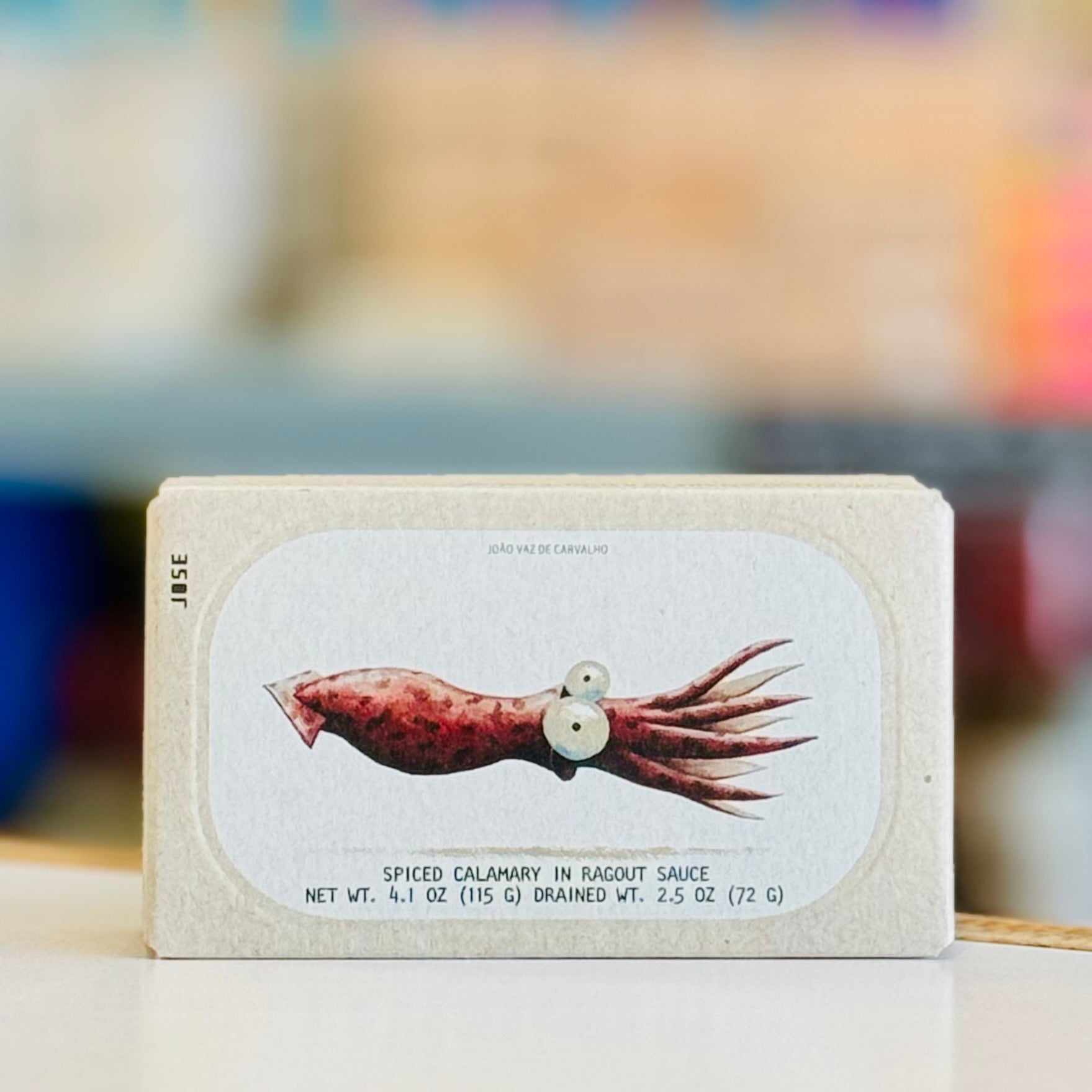 Packaging of spiced calamary with a label on a blurred background