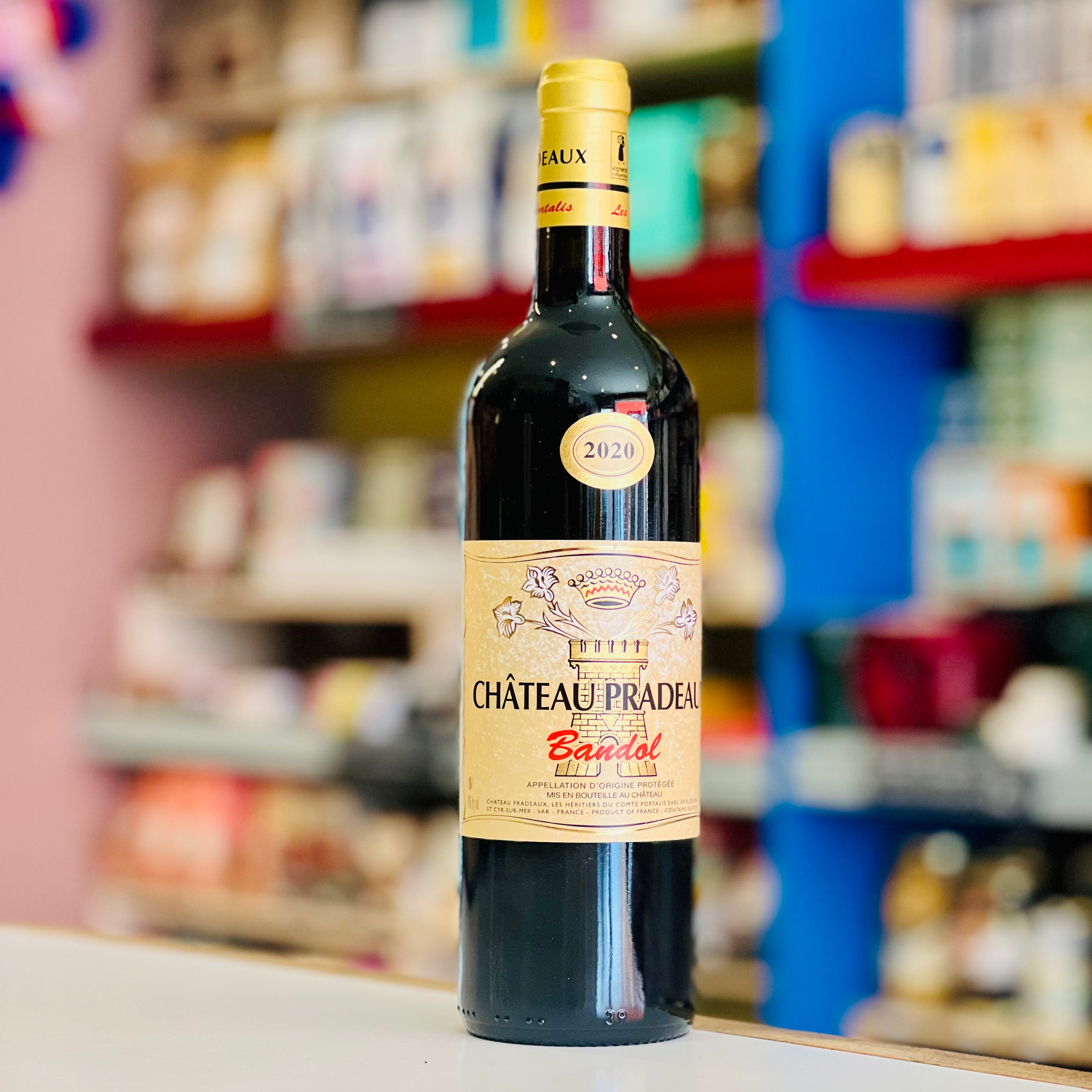 Bottle of Château Pradeau Bandol wine on a shelf with blurred store shelves in the background