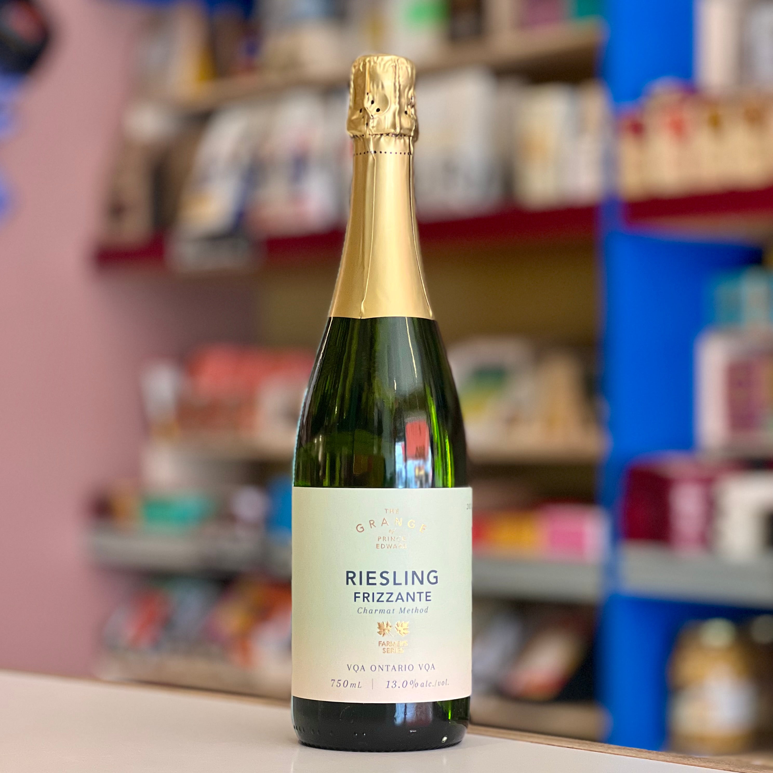 A bottle of Riesling Frizzante sparkling wine by O. Barolo, standing on a white surface with a blurred store background.