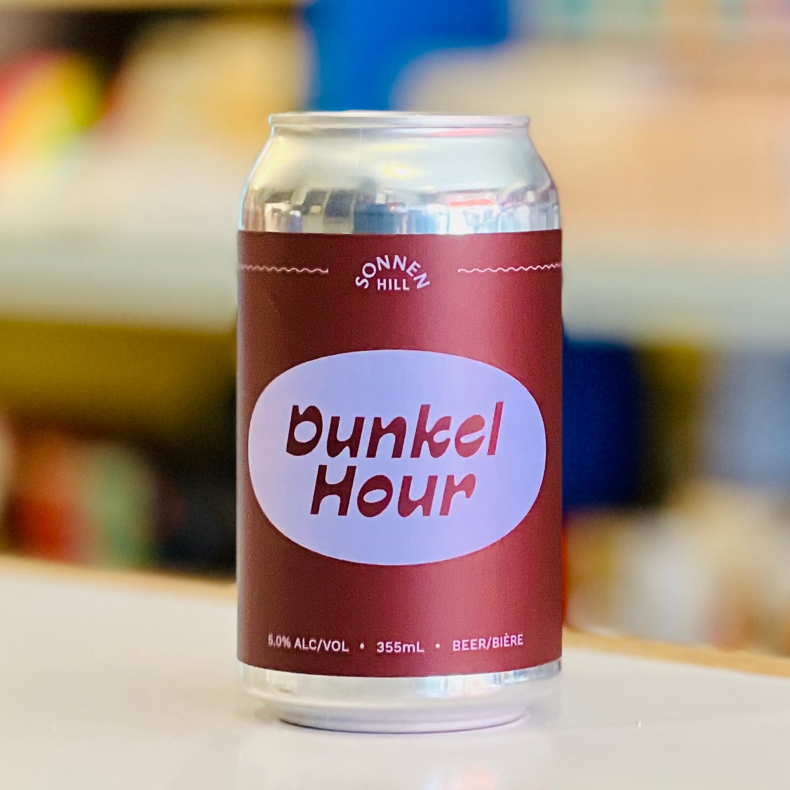 Can of Sonnen Hill Dunkel Hour beer on a blurred background