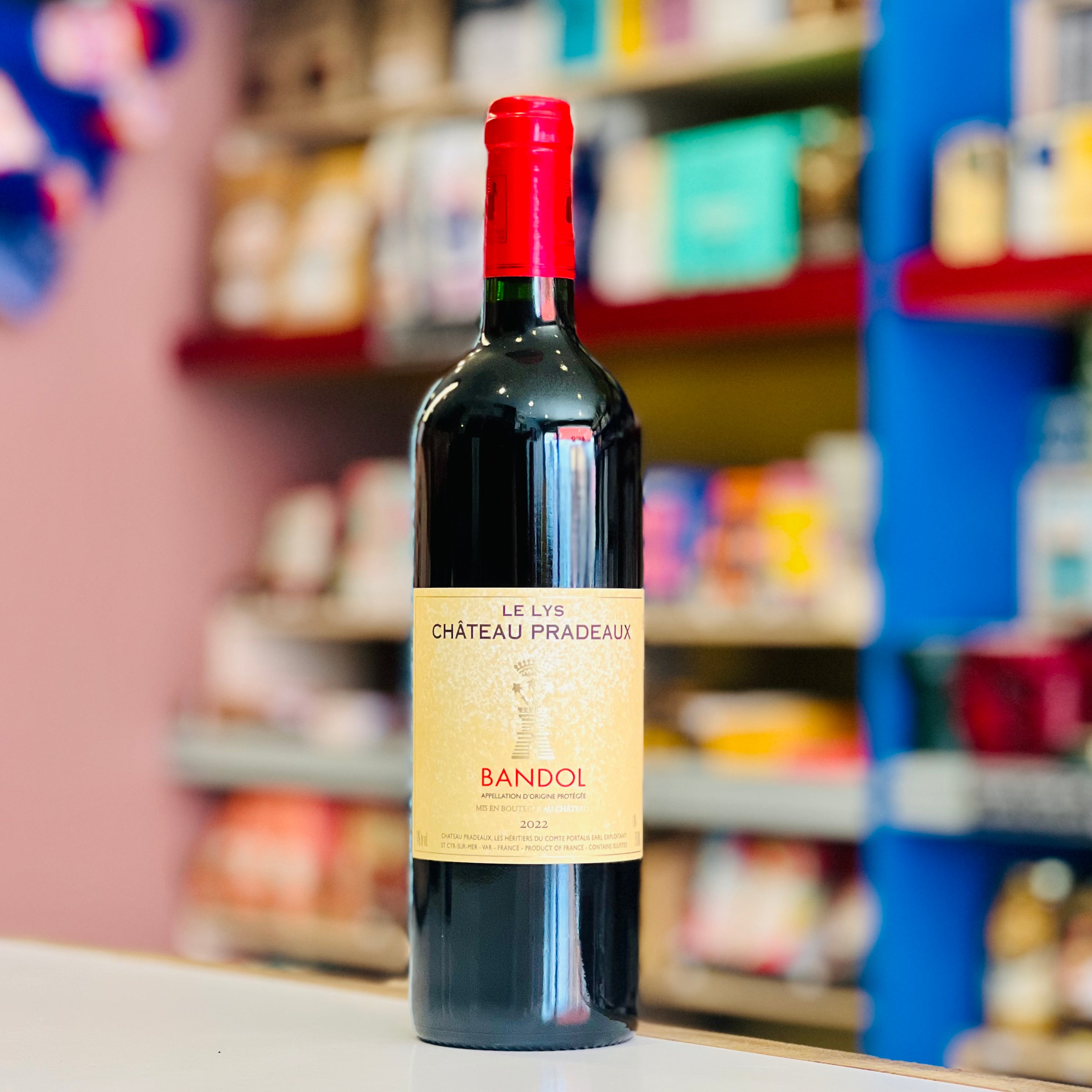 Bottle of Château Pradeaux Bandol wine on a shelf with blurred store background