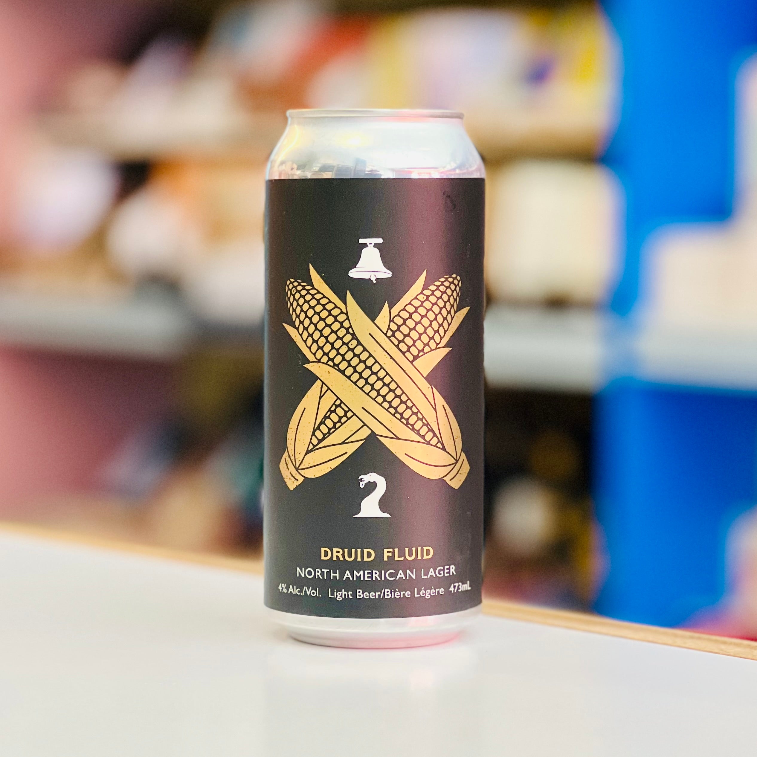 Can of Druid Fluid beer with corn design on a shelf