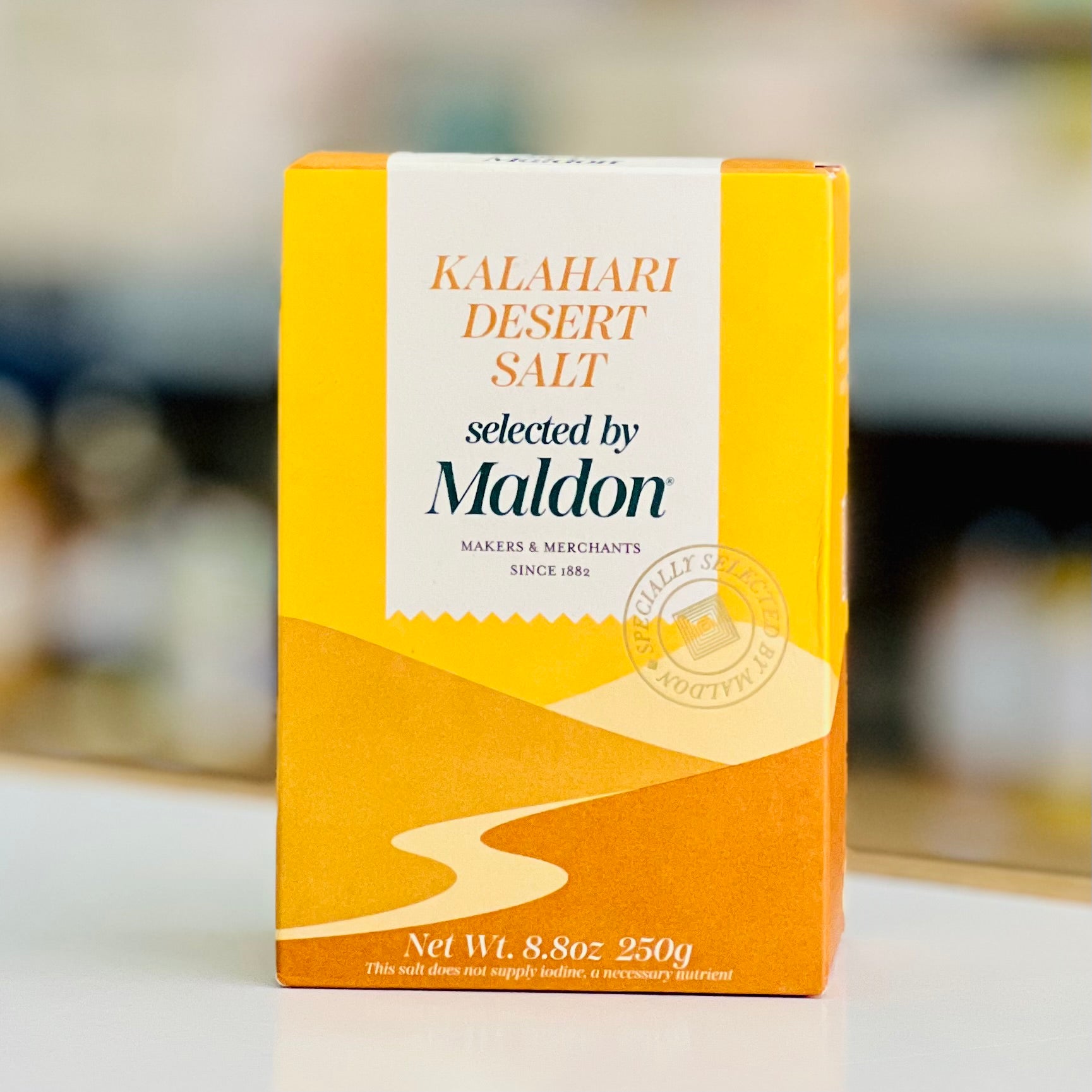 Box of Kalahari Desert Salt by Maldon on a blurred background