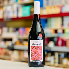 Wine bottle with a colorful label on a shelf in a store
