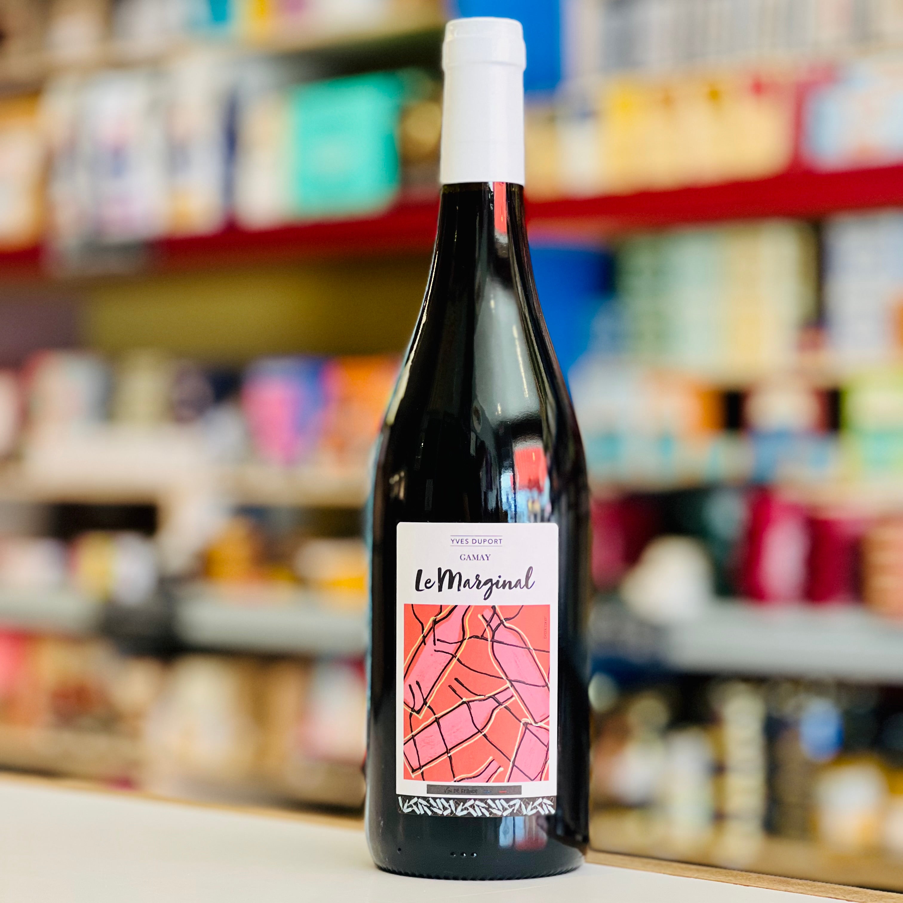 Wine bottle with a colorful label on a shelf in a store