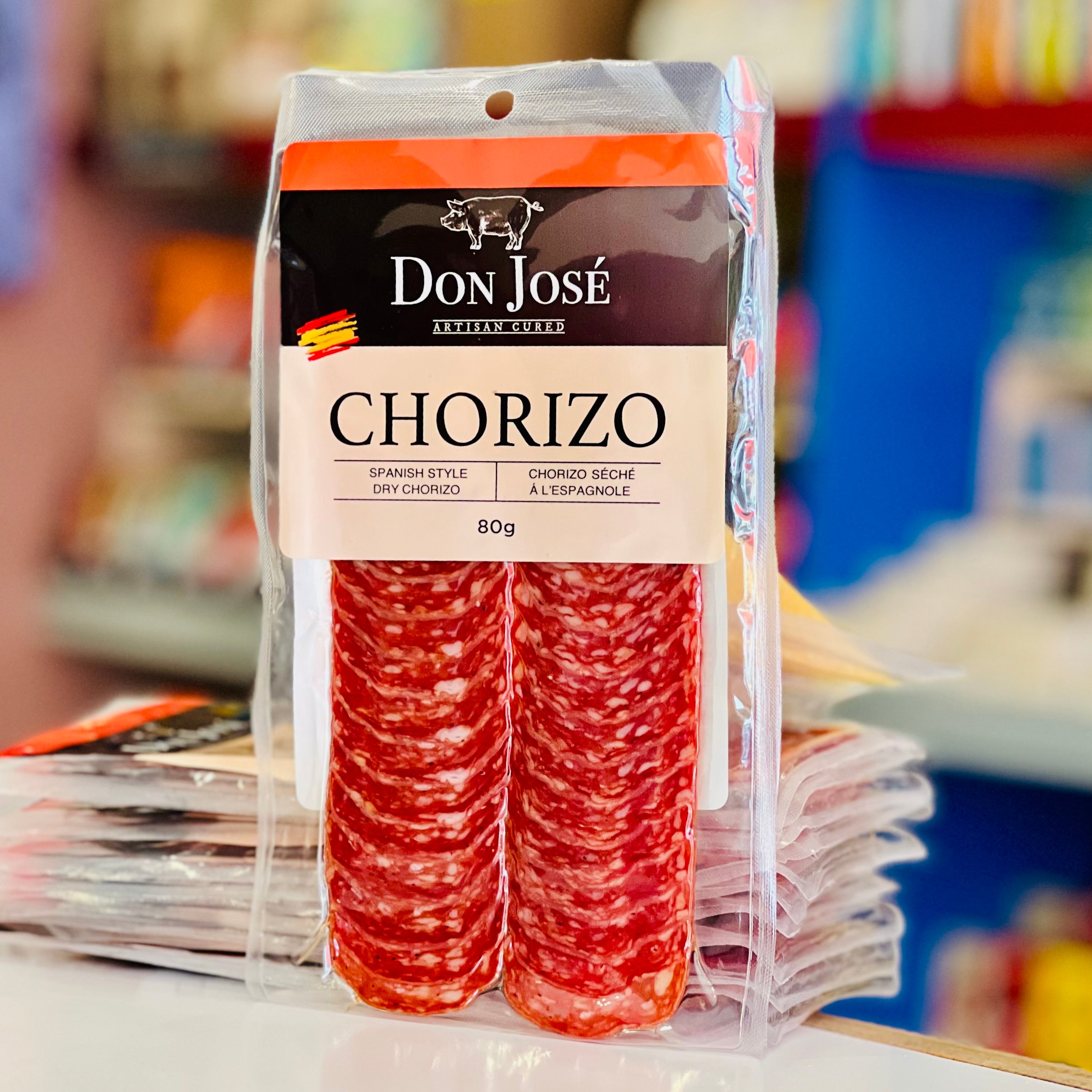 Packaged chorizo with Don Jose branding on a blurred store shelf background