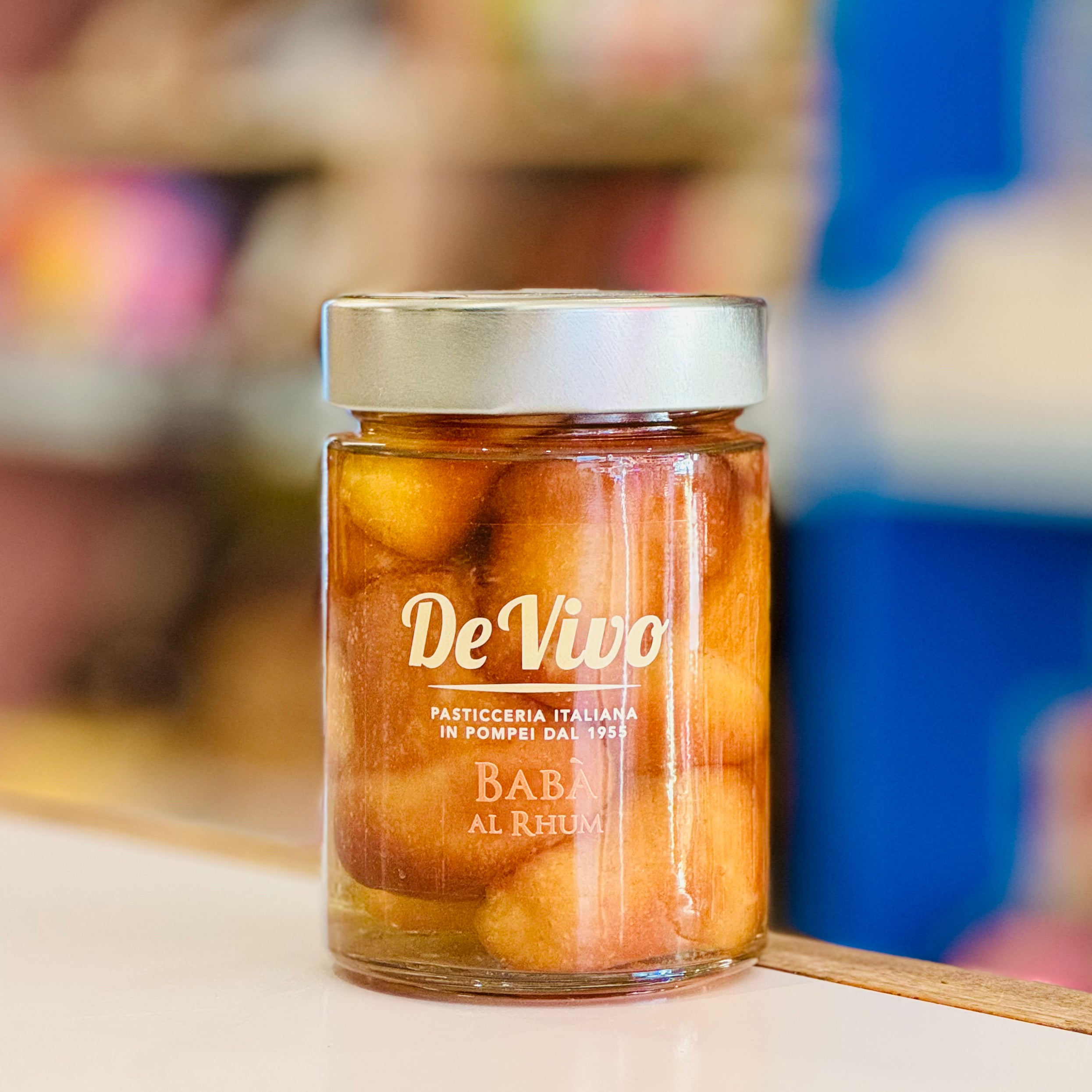 Jar of De Vivo Baba al Rum on a blurred background