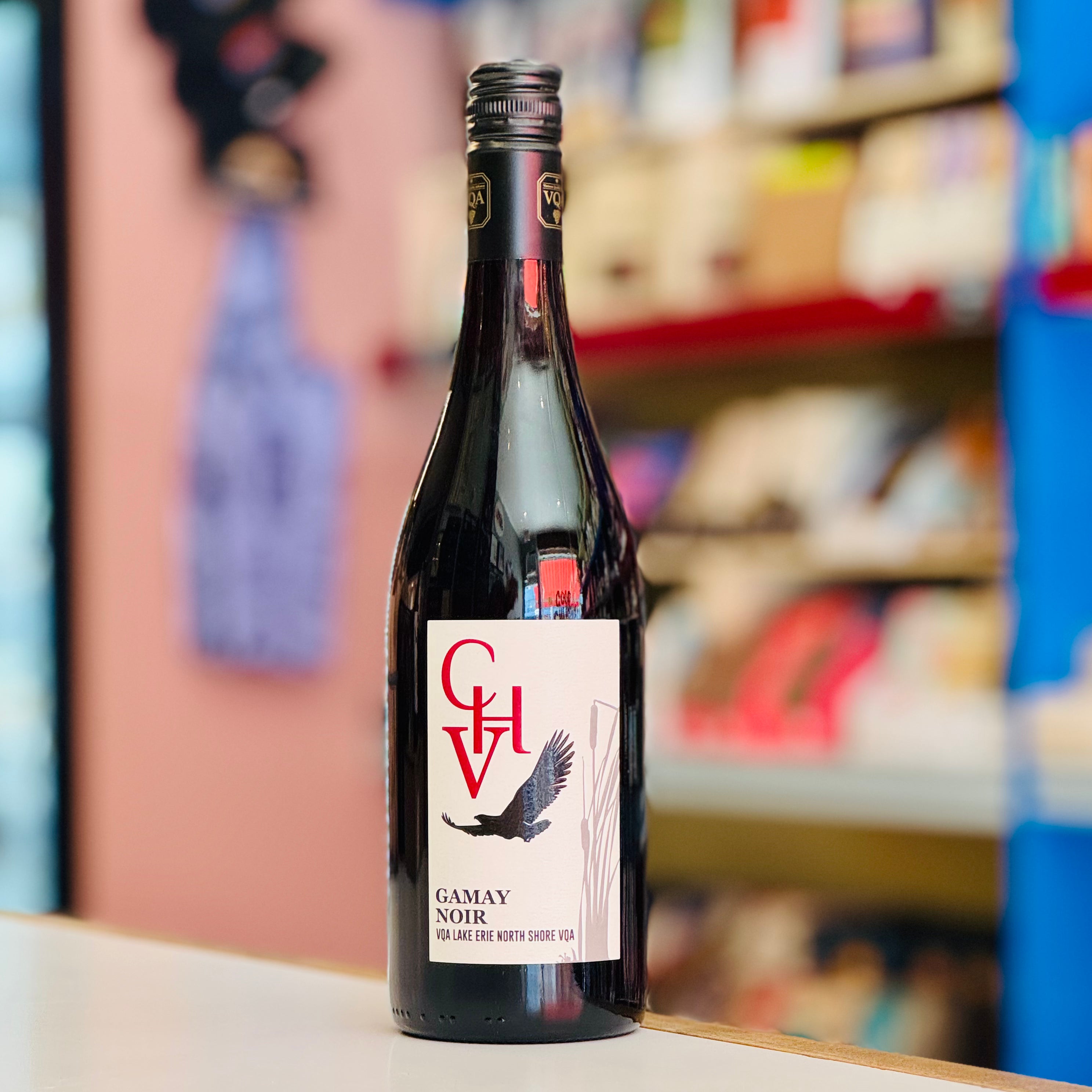 Wine bottle with a label featuring an eagle design on a shelf in a store.