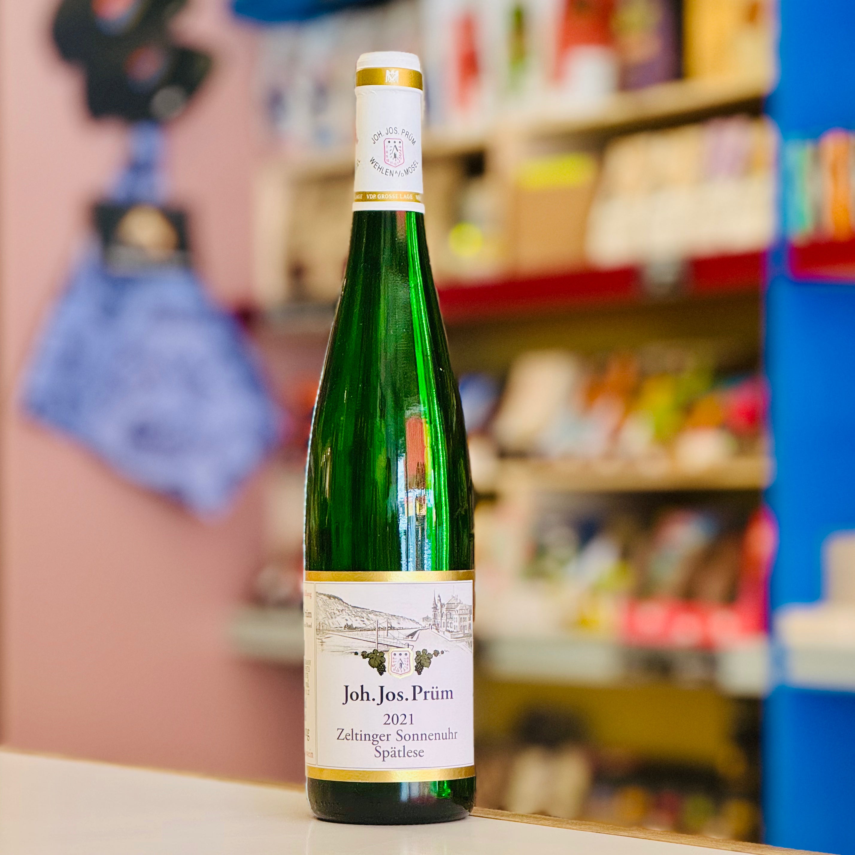 Green wine bottle with a label in a store setting