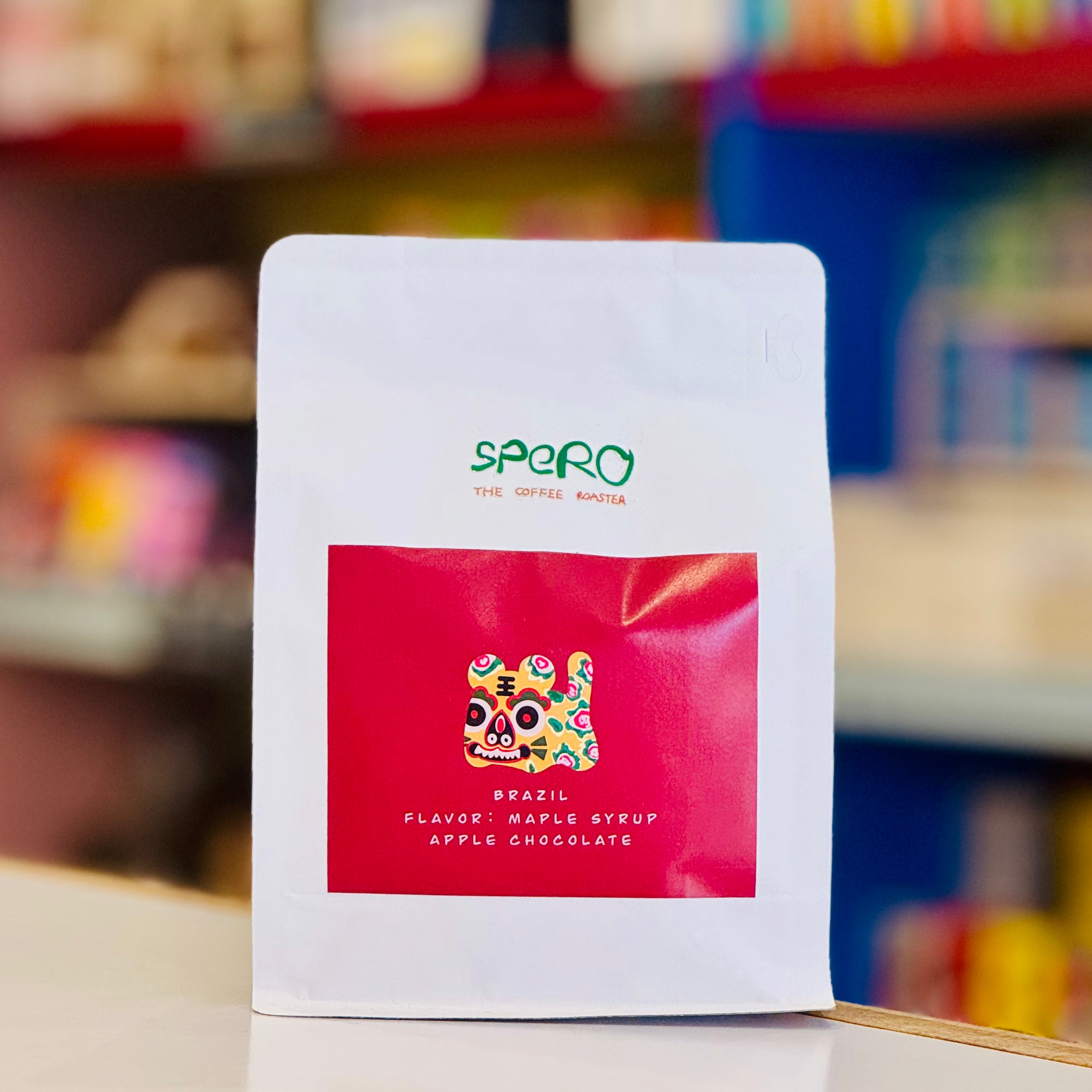 Spero coffee package with colorful label on a blurred background
