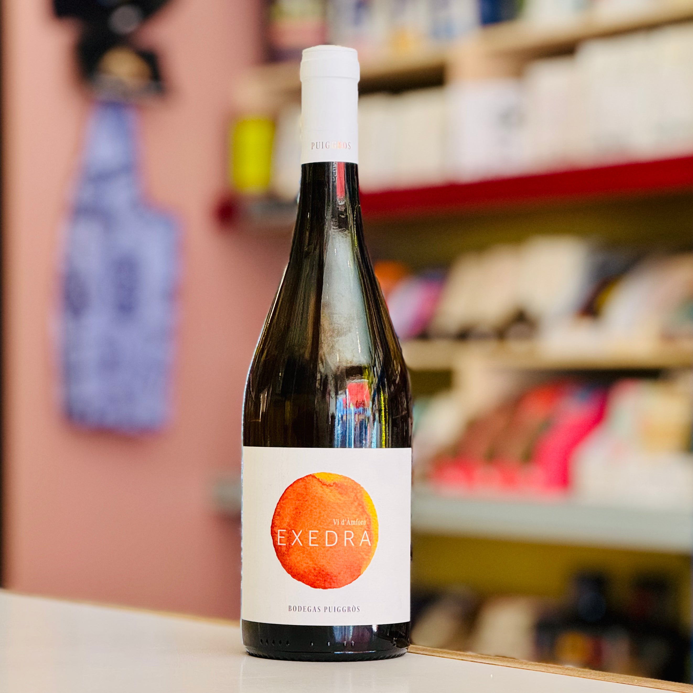 Bottle of Exedra wine on a shelf with a blurred store background
