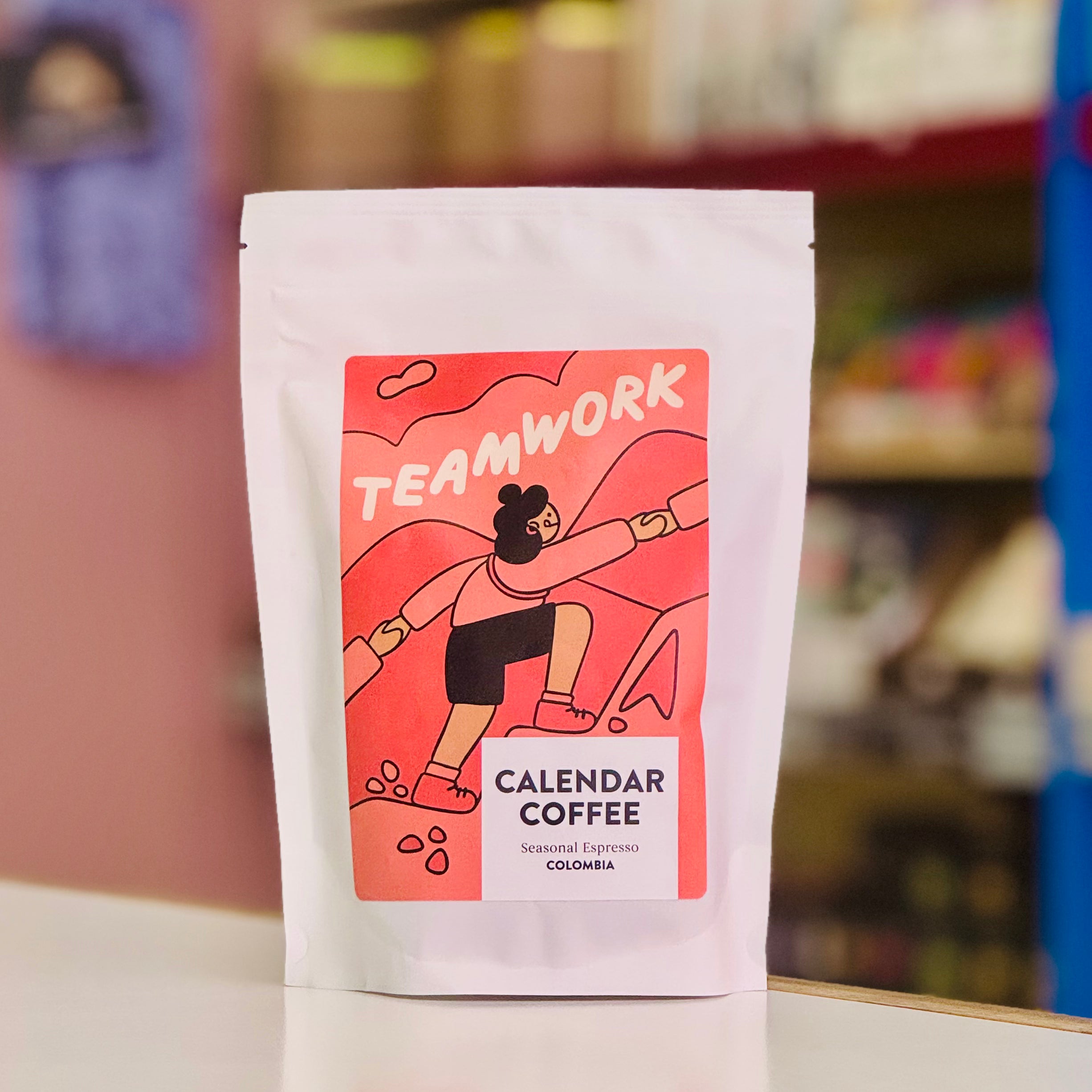 Coffee package with 'Teamwork' label on a blurred background