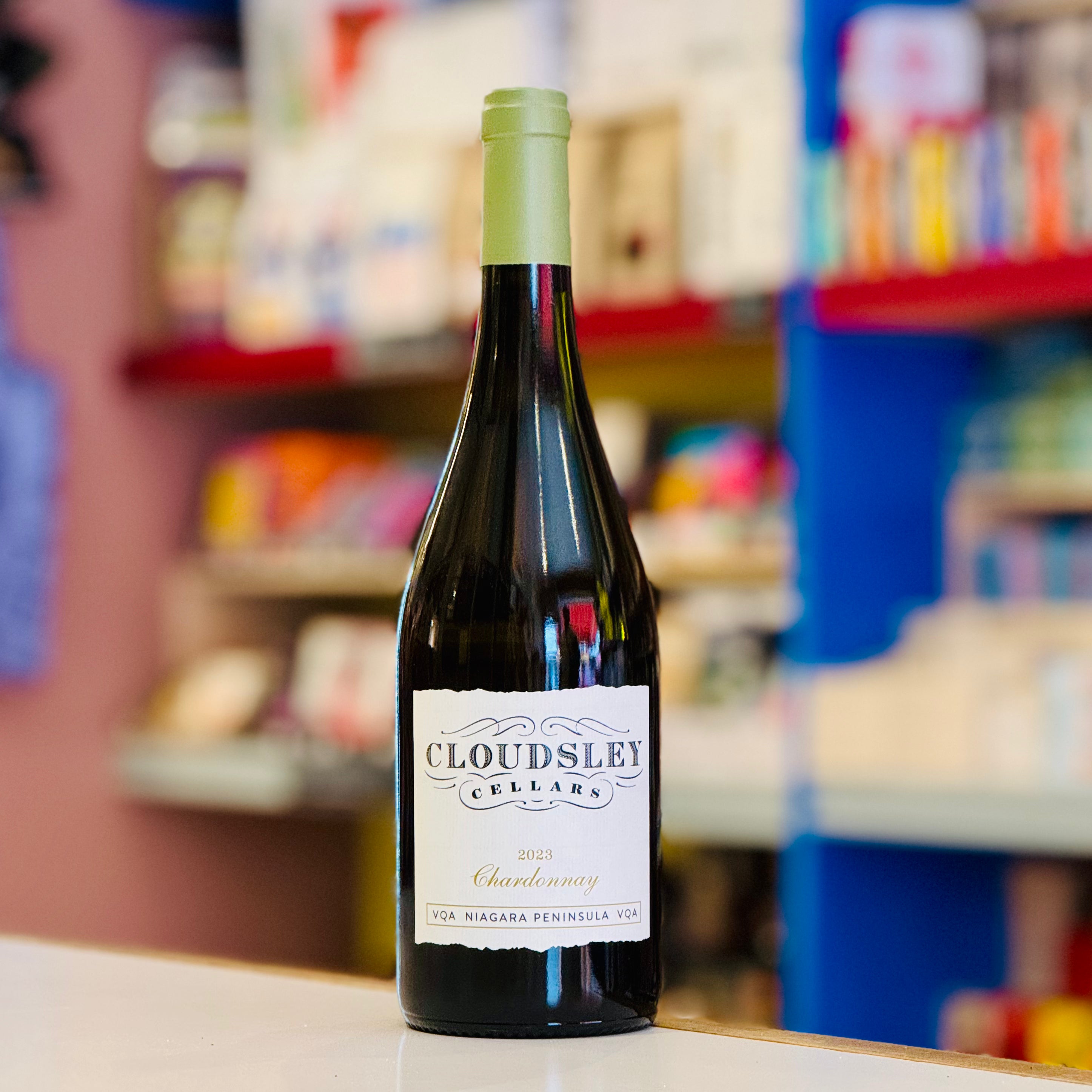 Bottle of Cloudsley Cellars Chardonnay wine on a counter with a blurred store background