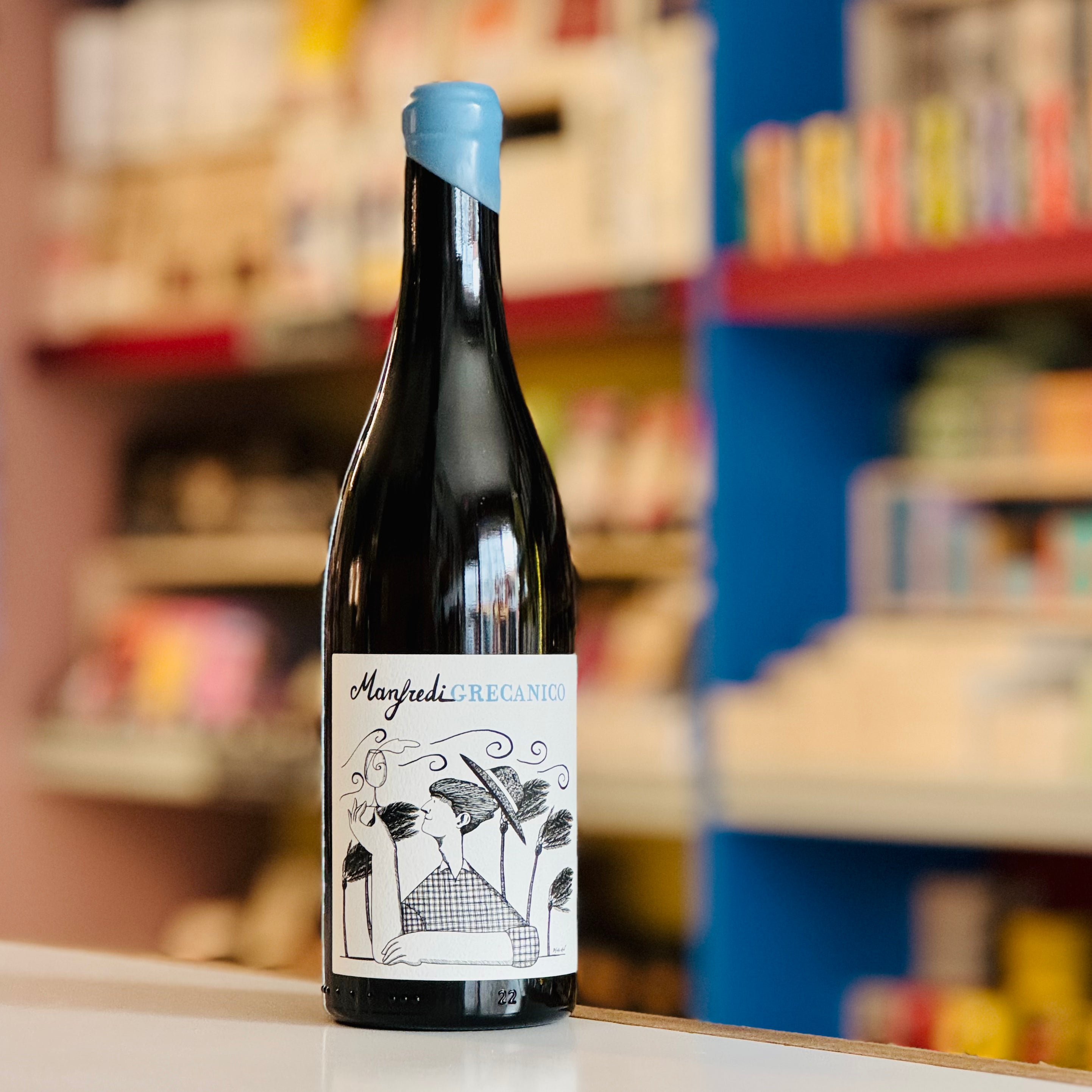 Wine bottle with a label on a shelf with books in the background