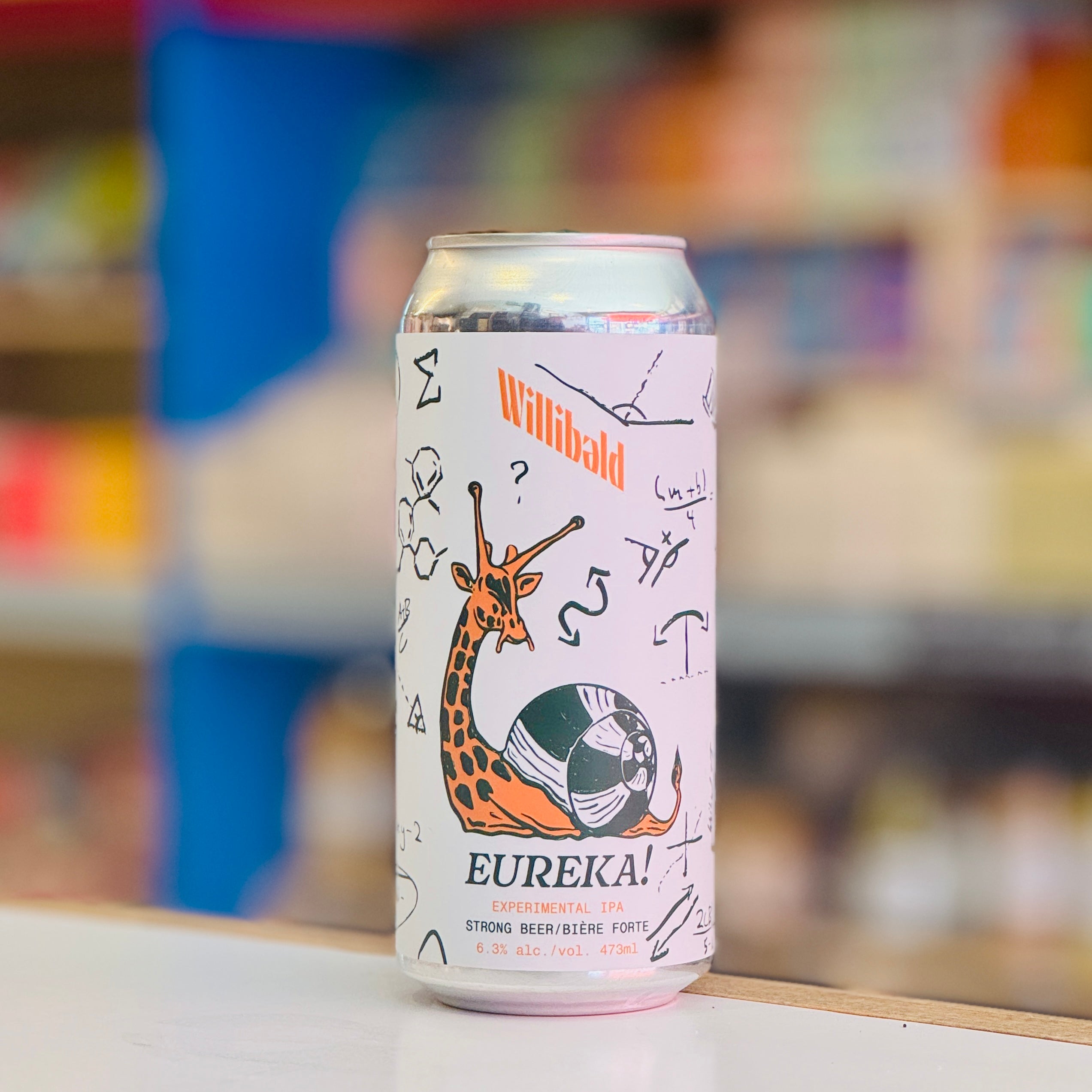 Can of Willibald Eureka beer with a colorful design on a blurred background