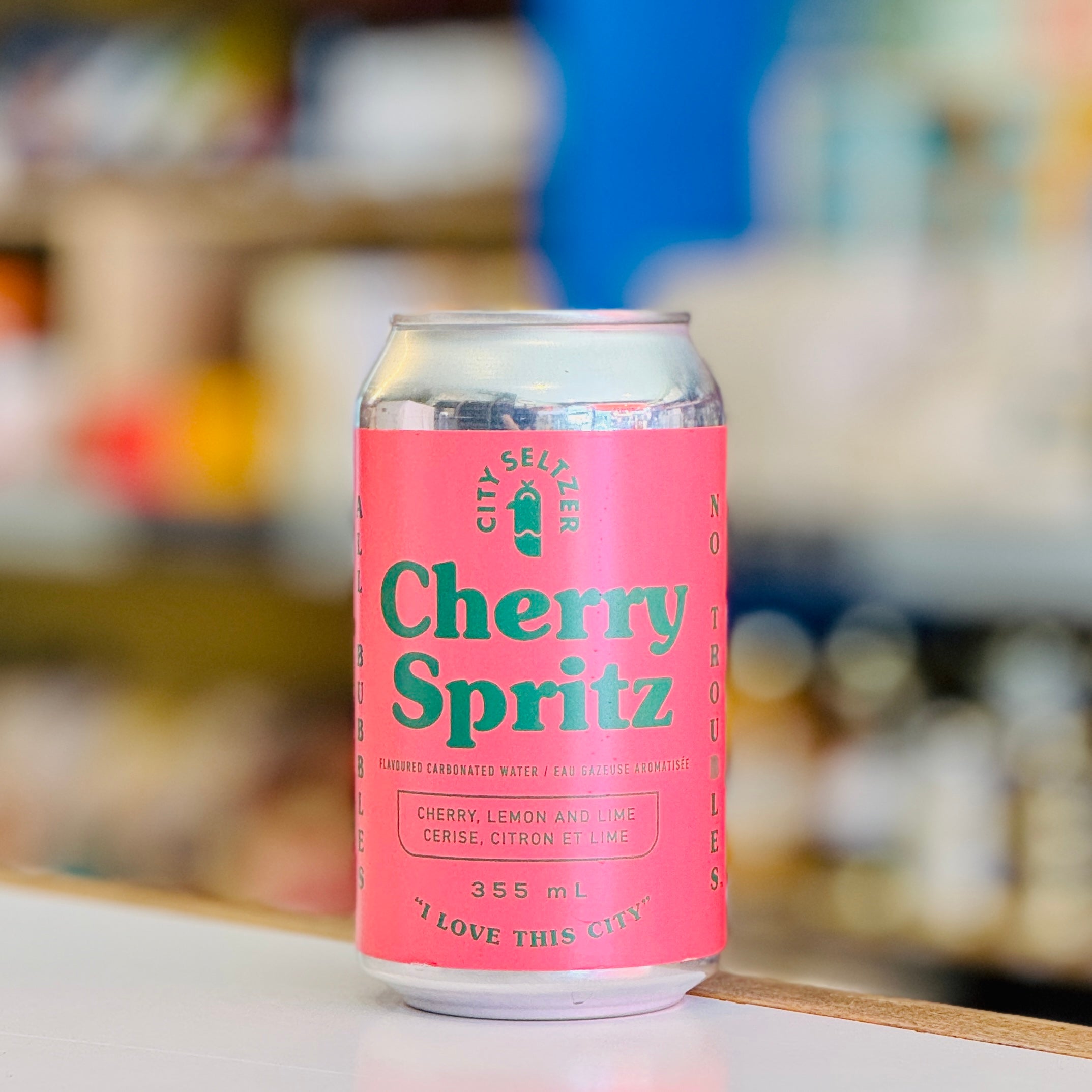 Pink can of Cherry Spritz with a blurred background