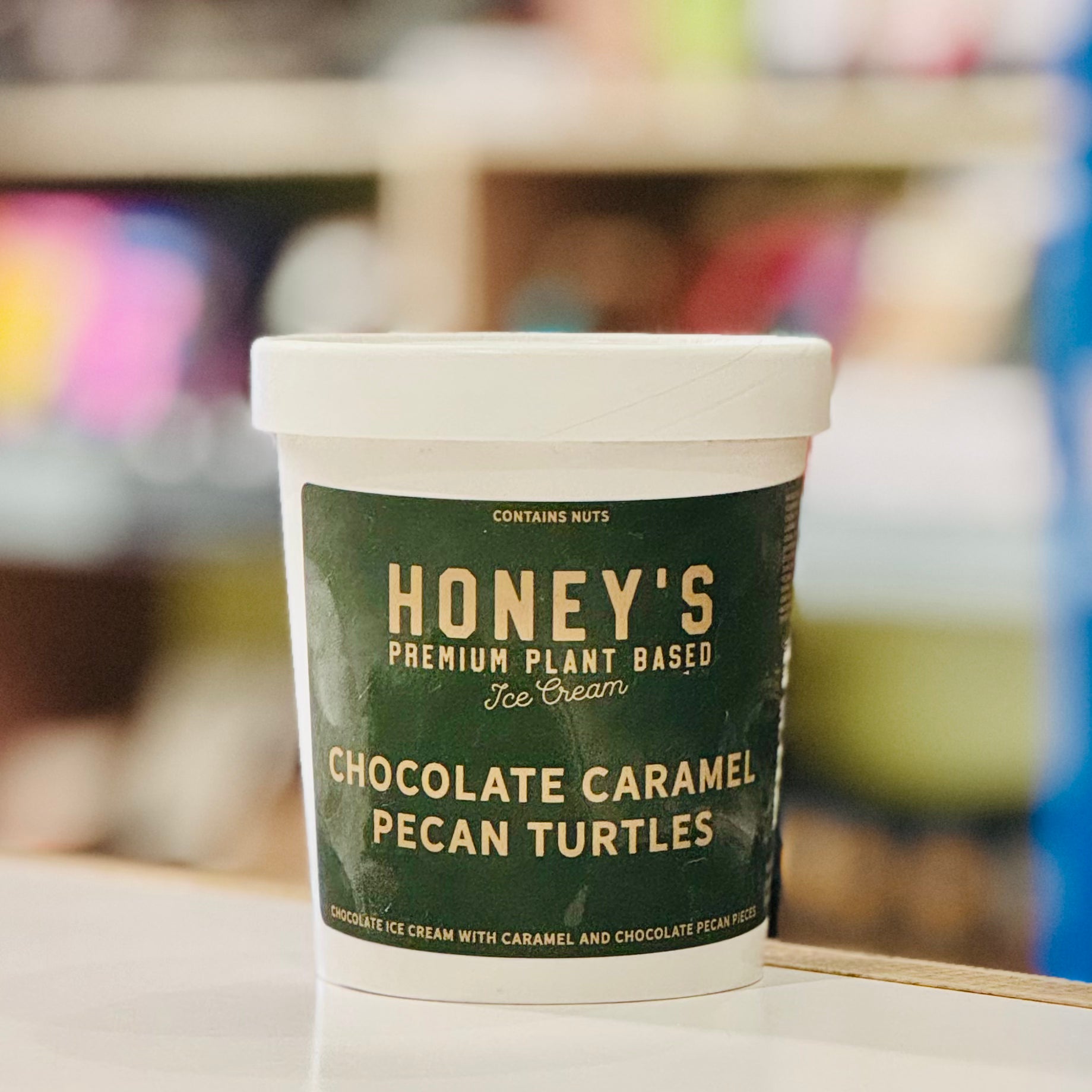 Container of Honey's Premium Plant-Based Ice Cream with a blurred background