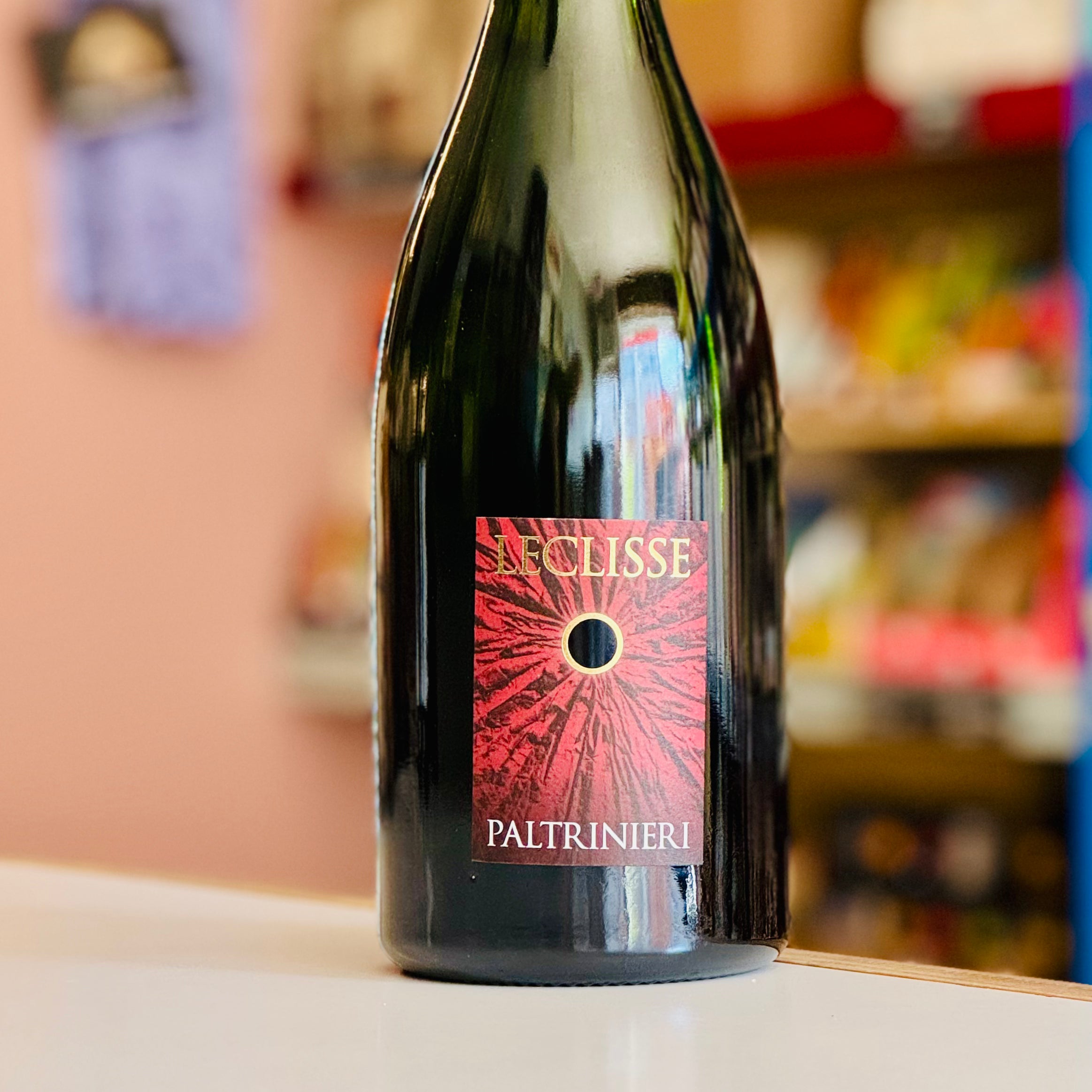 Wine bottle with 'La Clisse Paltrinieri' label on a shelf.