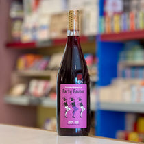 Bottle of 'Party Favour' red wine with a pink label on a shelf in a store.