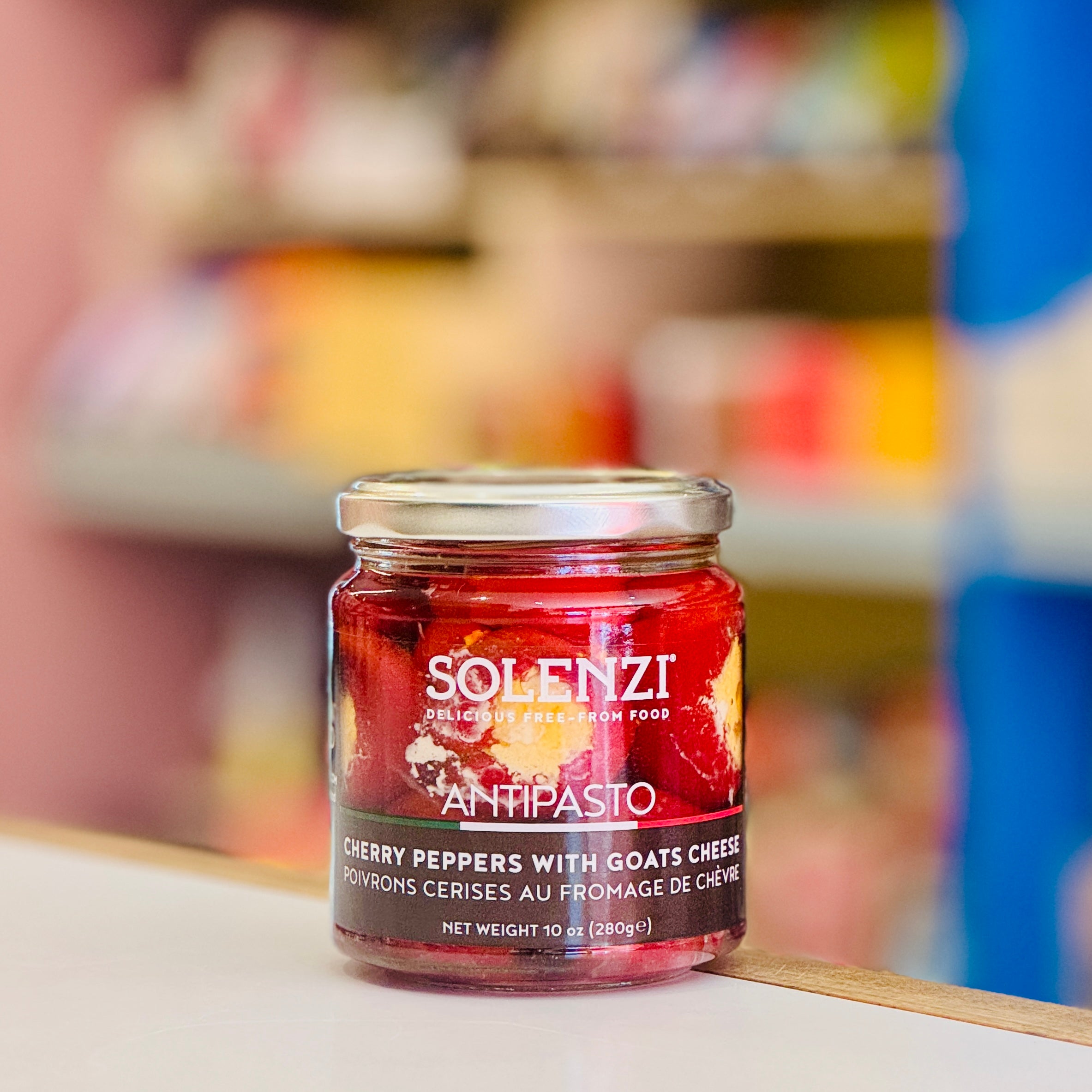 Jar of Solenzi Antipasto cherry peppers with goats cheese on a shelf in a store.