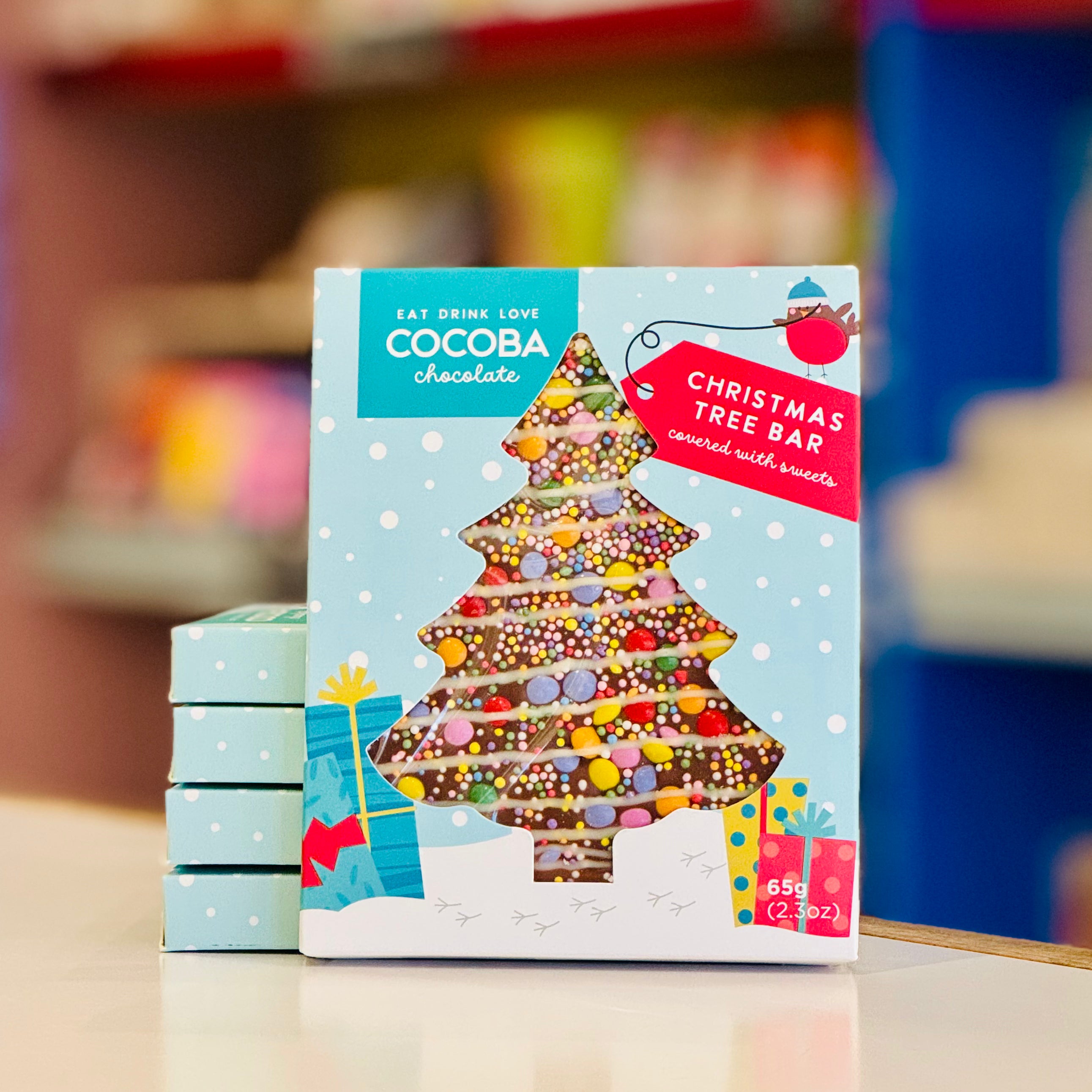 Cocoba chocolate Christmas tree bar packaging on a blurred background