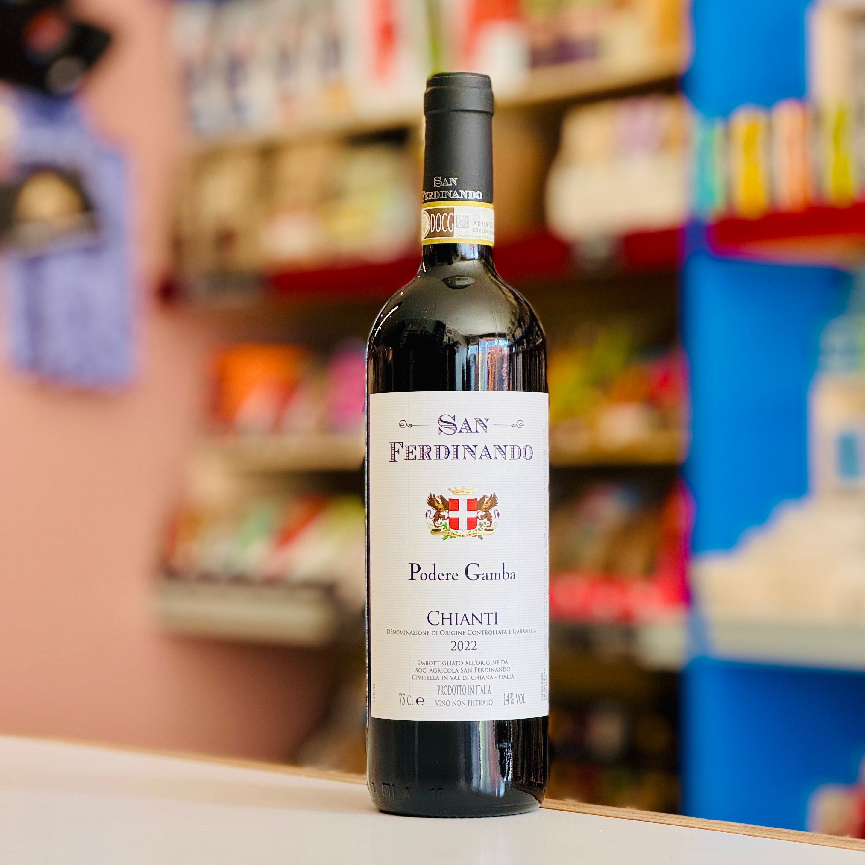 Bottle of San Ferdinando Chianti wine on a shelf with blurred store background