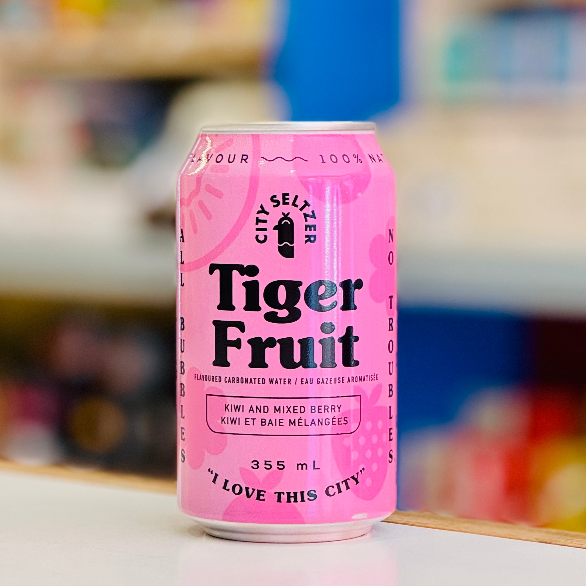 Pink can of Tiger Fruit seltzer water with a blurred background