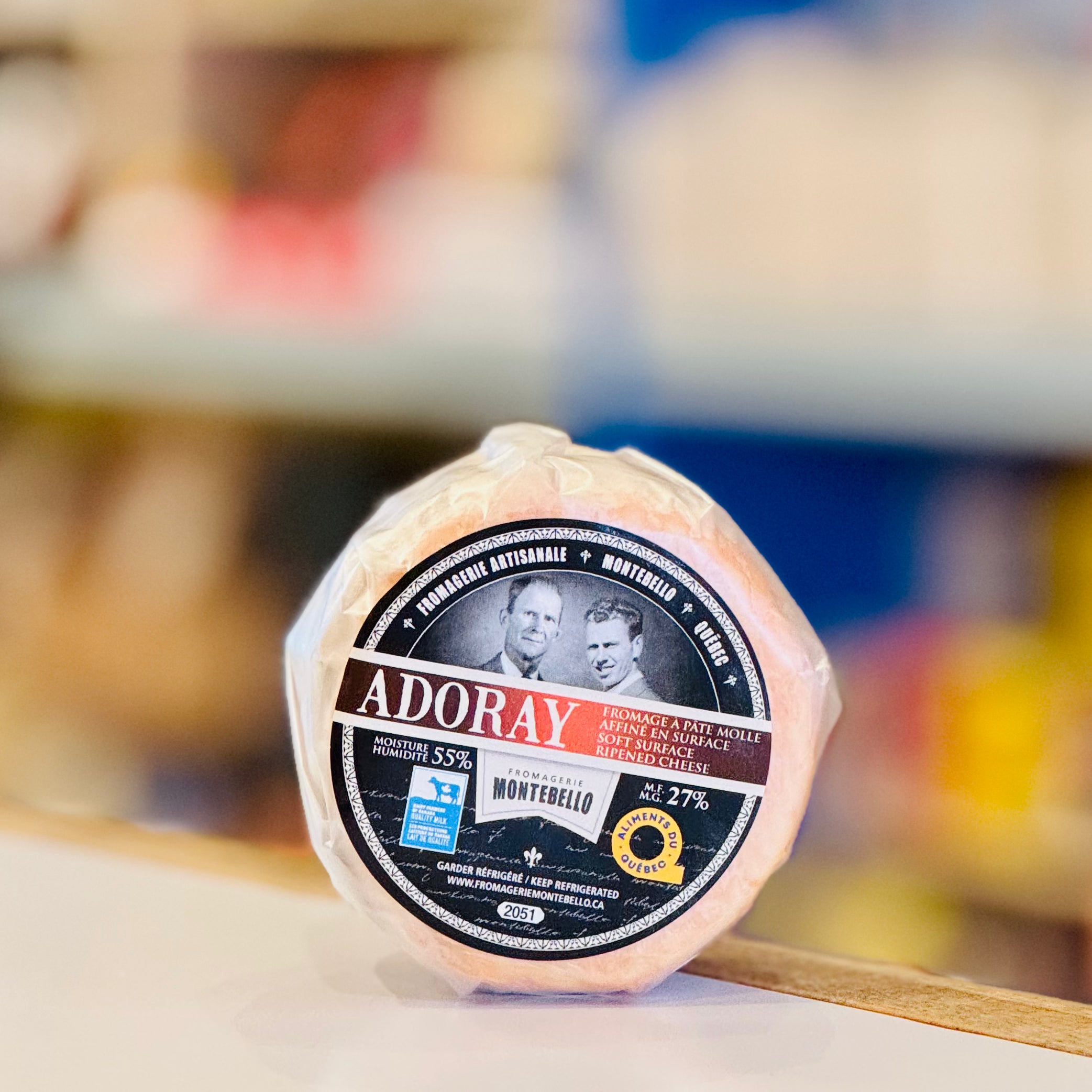 Adoray cheese wheel with a blurred background