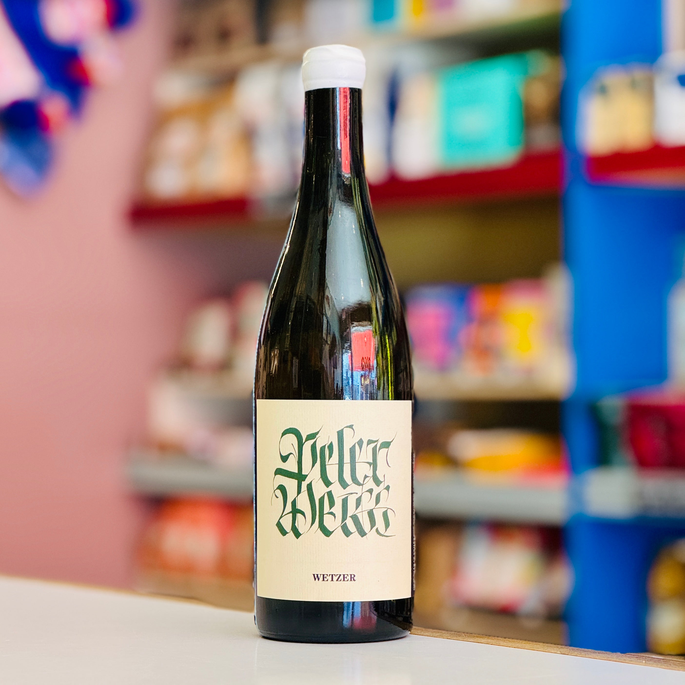 Bottle of Wetter beer with a colorful store shelf in the background